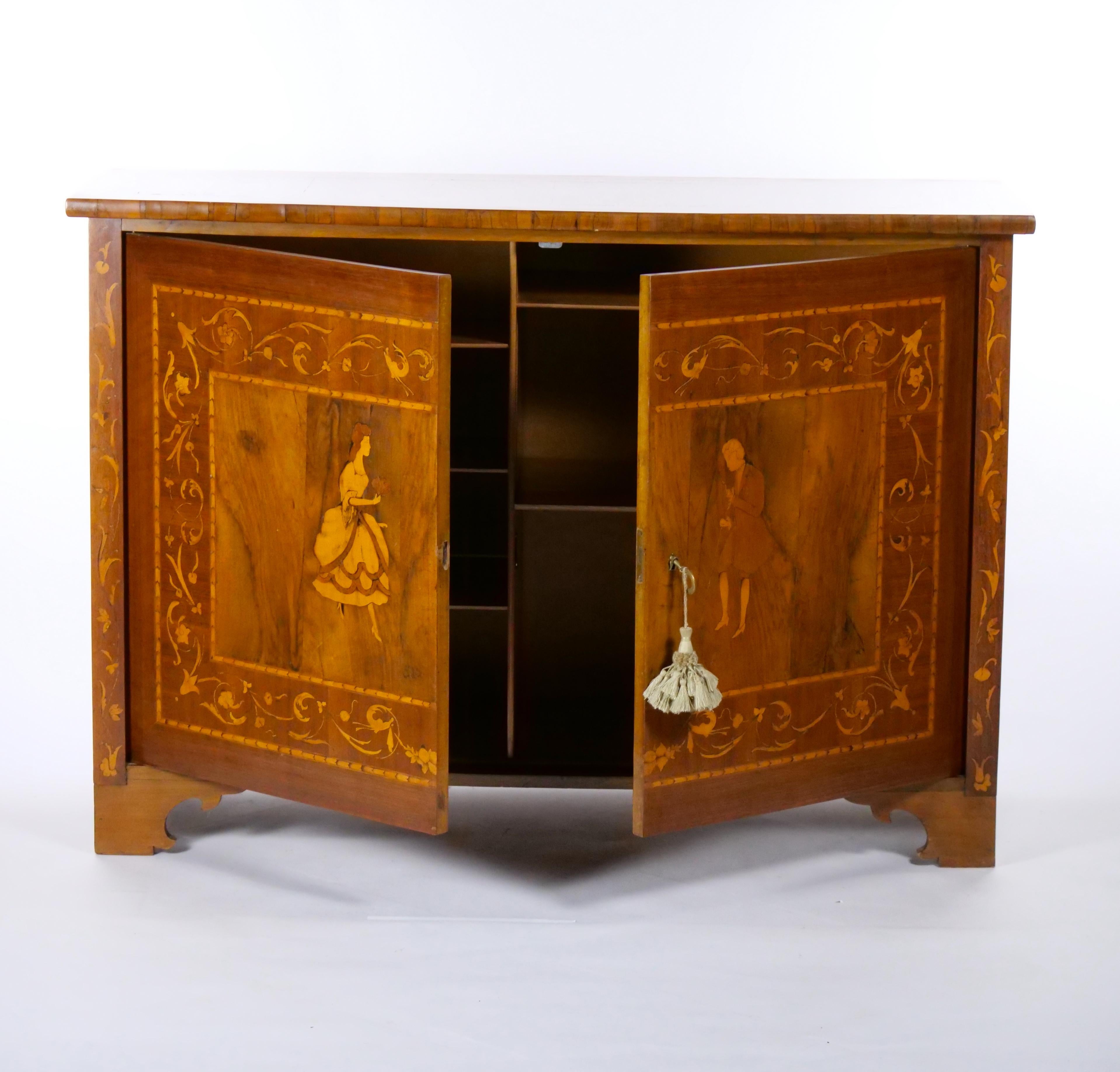 Beautifully crafted French marquetry wood sideboard / server cabinet with double inlaid front door featuring individuals in period attire. The sides of the credenza features beautiful inlaid decoration wood pattern all raised on short hand carved