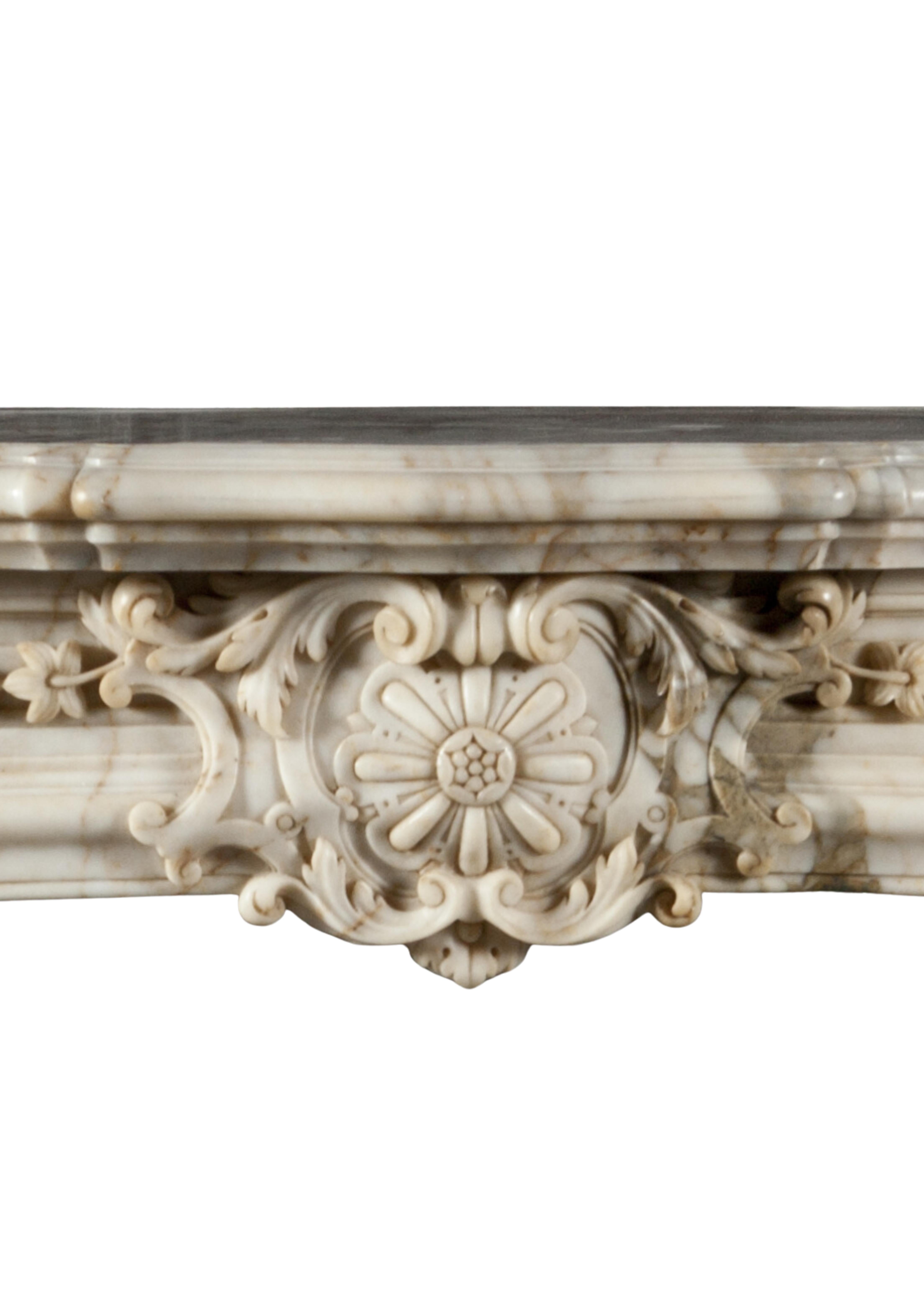 Small and beautiful reproduction of a regency fireplace made in old Italian arabescato marble. The serpentine paneled frieze is centered by classical french regency cartouche and flanked by nicely carved end blocks .