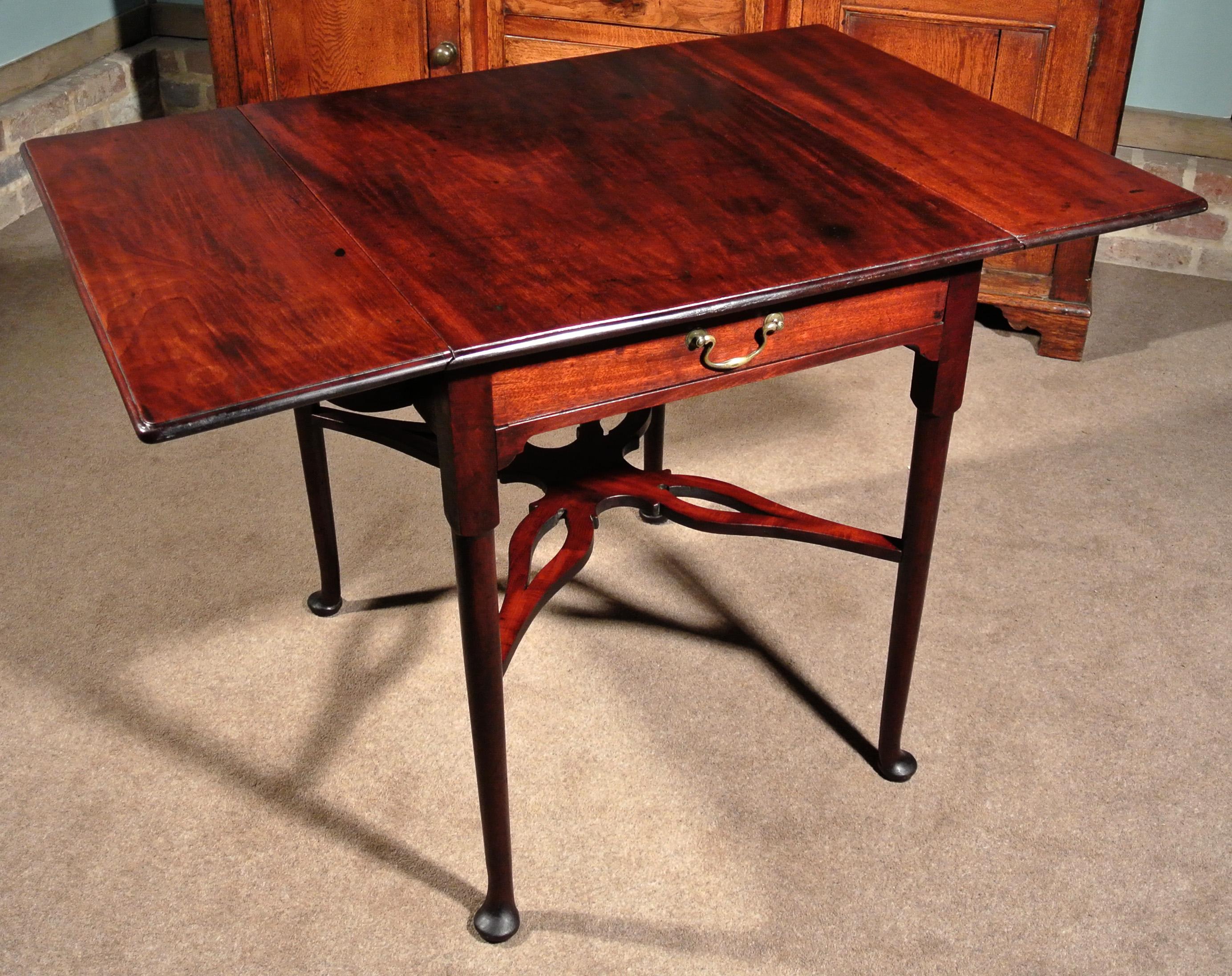 A particularly fine quality solid Cuban mahogany pembroke table with attractive pieced X-stretcher in the Chippendale manner. The three part top cut from a single piece of solid Cuban mahogany and carefully made so that the figuring flows naturally