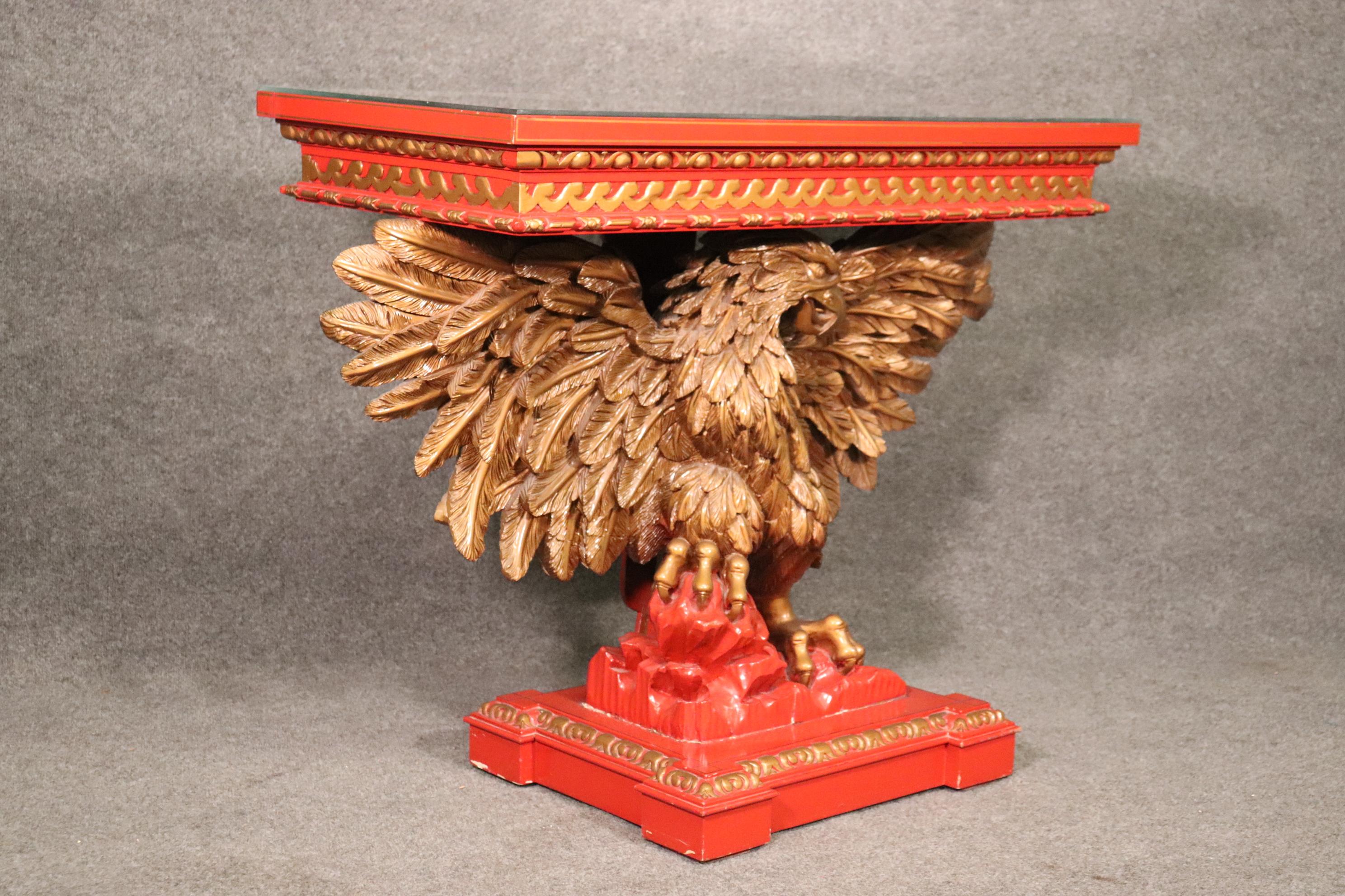 This is a killer red lacquer carved eagle Georgian console table with a chinoiserie painted top and gold hued eagle. The table measures 35 tall x 44 wide x 20 deep.