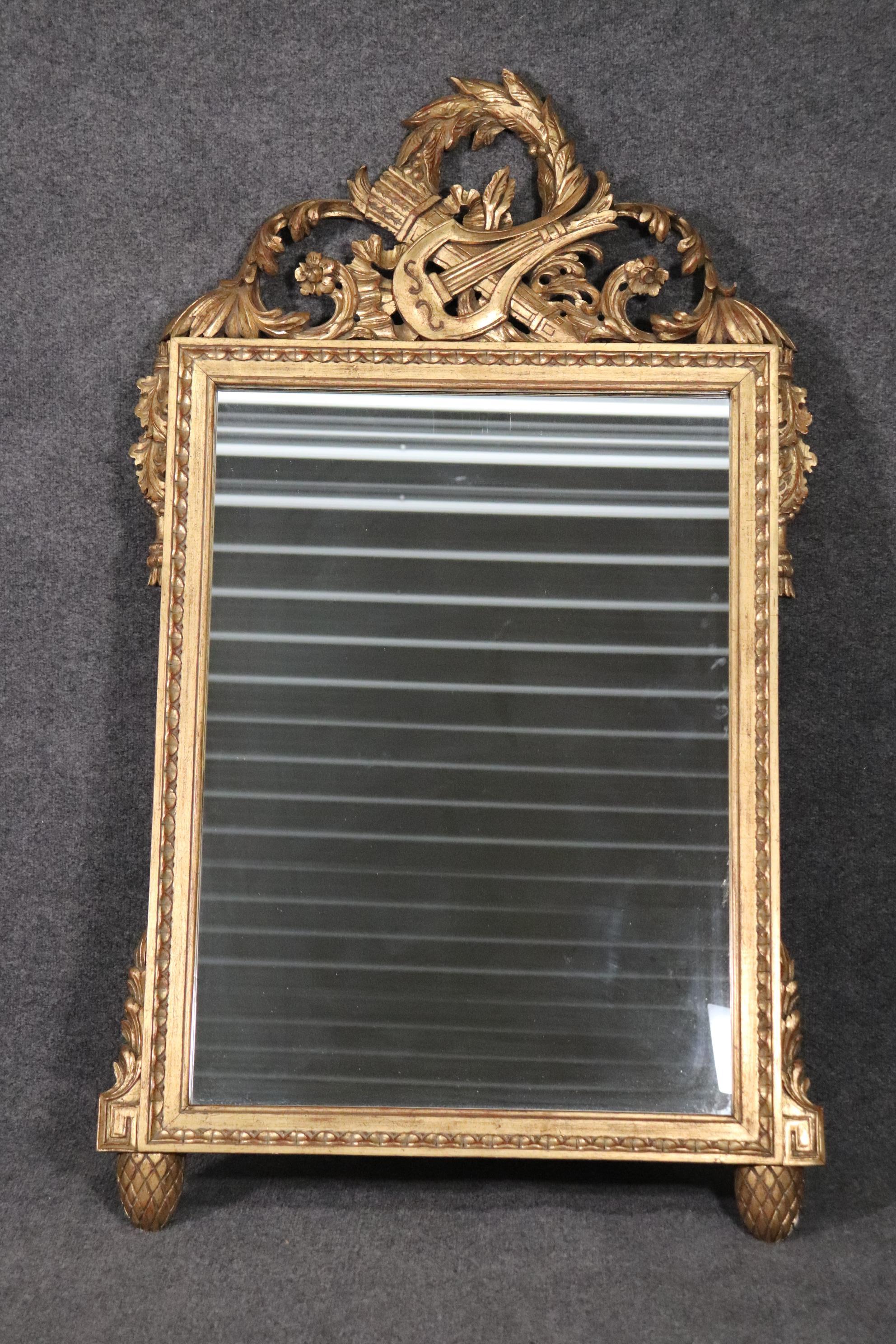 This is a beautiful gilded mirror depicting a Lyre and quiver of arrows for the hunt. The mirror is absolutely classic and can work in any decor or design scheme. The mirror measures 52 tall x 31 wide x 1.5 inches thick. 