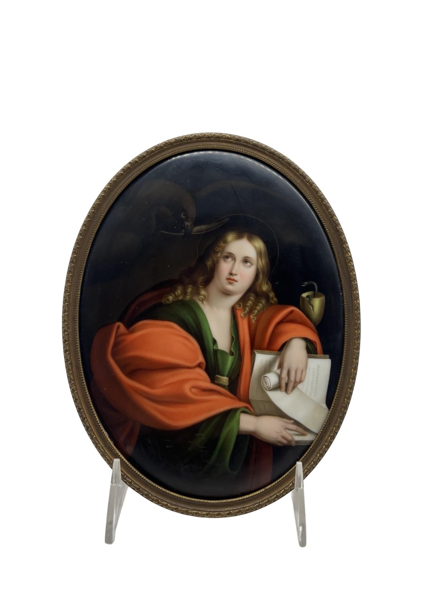 Continental, 19th century. 
A fine quality antique porcelain plaque depicting John The Evangelist after the original antiquity by Domenichino (Italian, 1581-1641). The plaque depicts a young John The Evangelist pearing at a hawk holding his quill