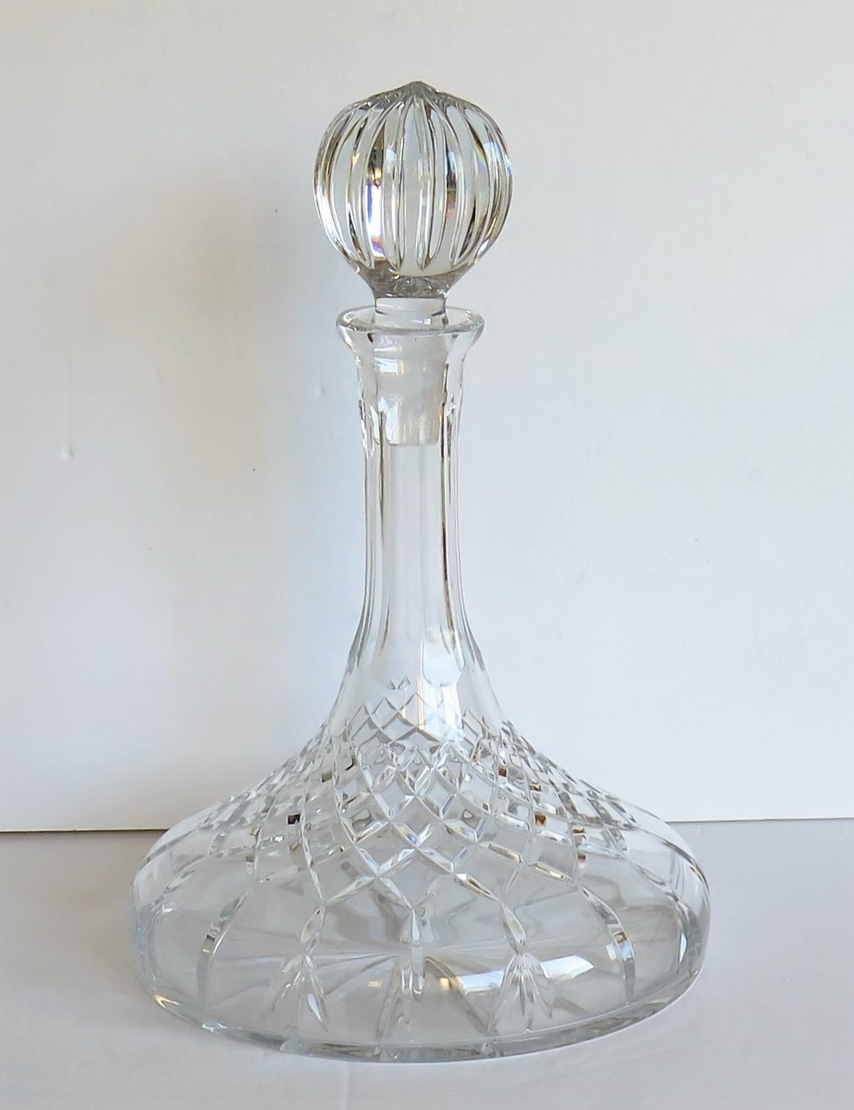 This is a large (over 1.2 litre) high quality ship's decanter with a wide base made from heavy lead crystal or cut-glass having a soft light grey color.

The decanter is well cut with a cross cut lower half with graduated diamonds and vertical
