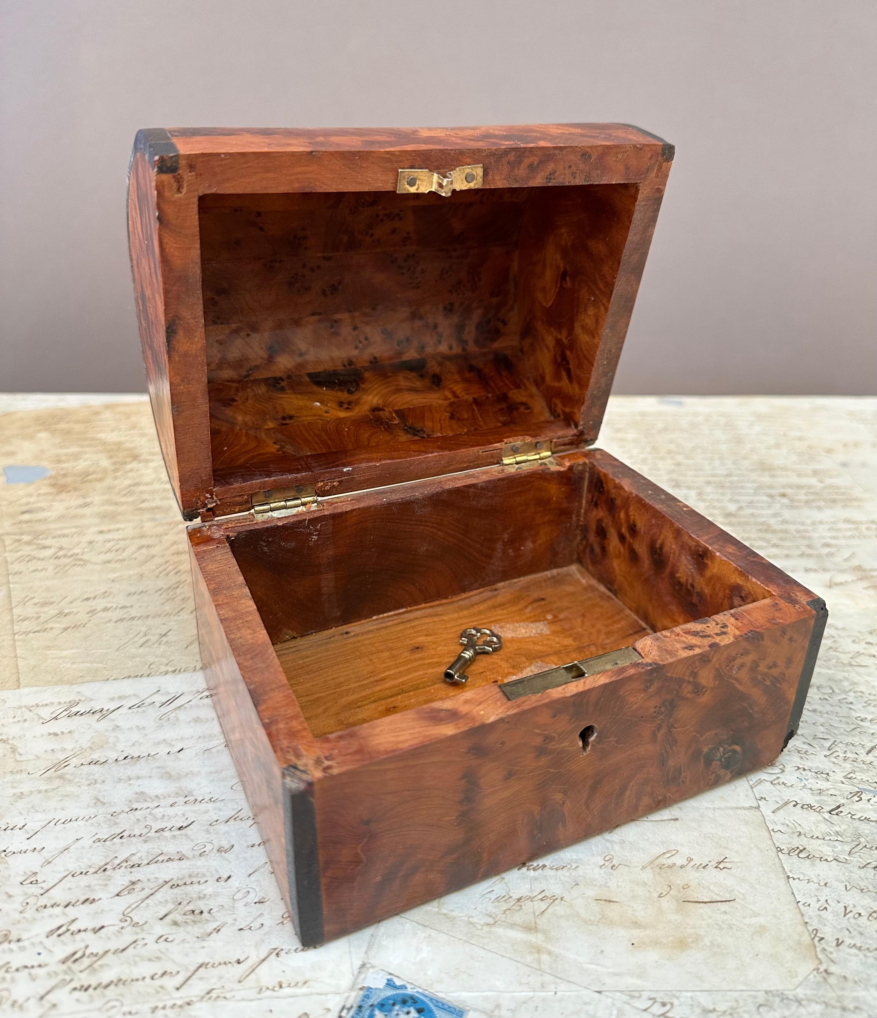 Fine Quality Late 19th Century “Dome“ Shaped Box . Beautifully Crafted, Constructed of “Burled Amboyna Wood” with Ebony edging. Nice small proportions with a deep patination and retaining the original lock and key. Made in France circa 1900