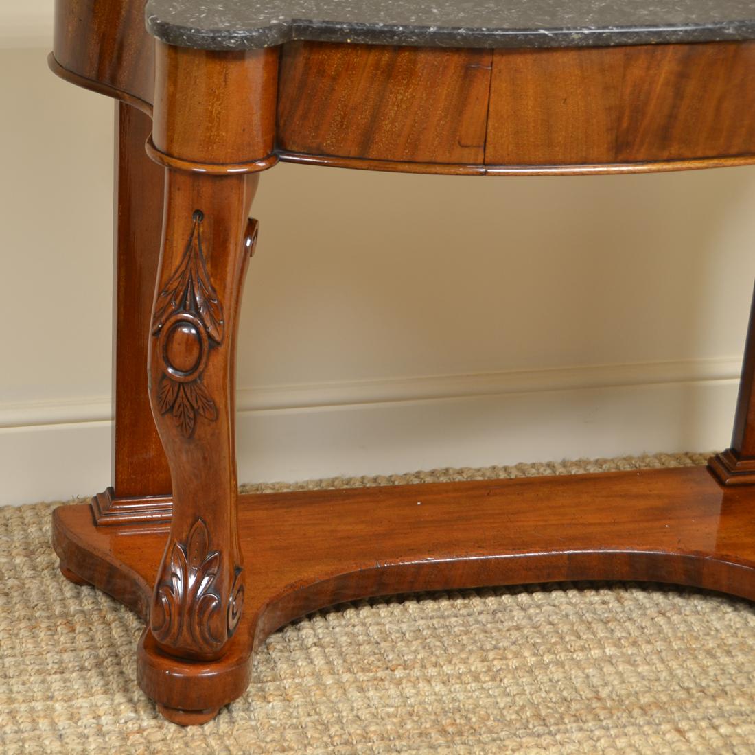Fine quality marble-top Victorian antique console table
Dating from circa 1870 this fine quality Victorian mahogany antique console table has a shaped marble top above a bow fronted frieze with concealed drawer and stands on elegant carved front