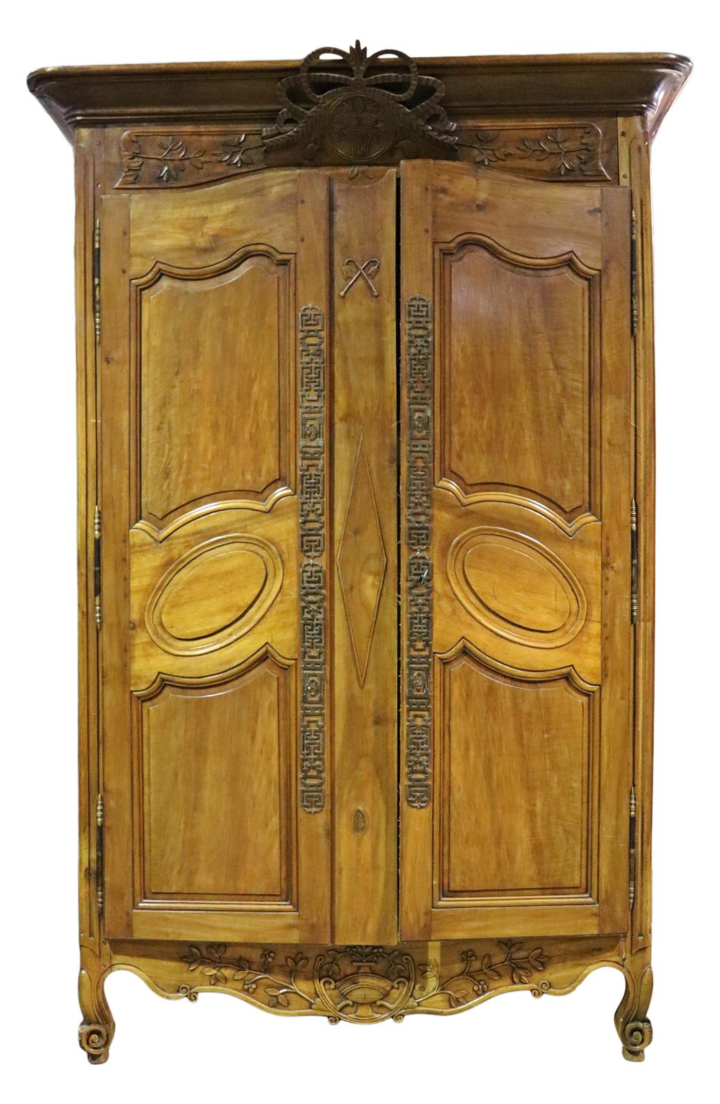 Carved wood. Two doors containing two shelves. Metal accents. Measures: 101