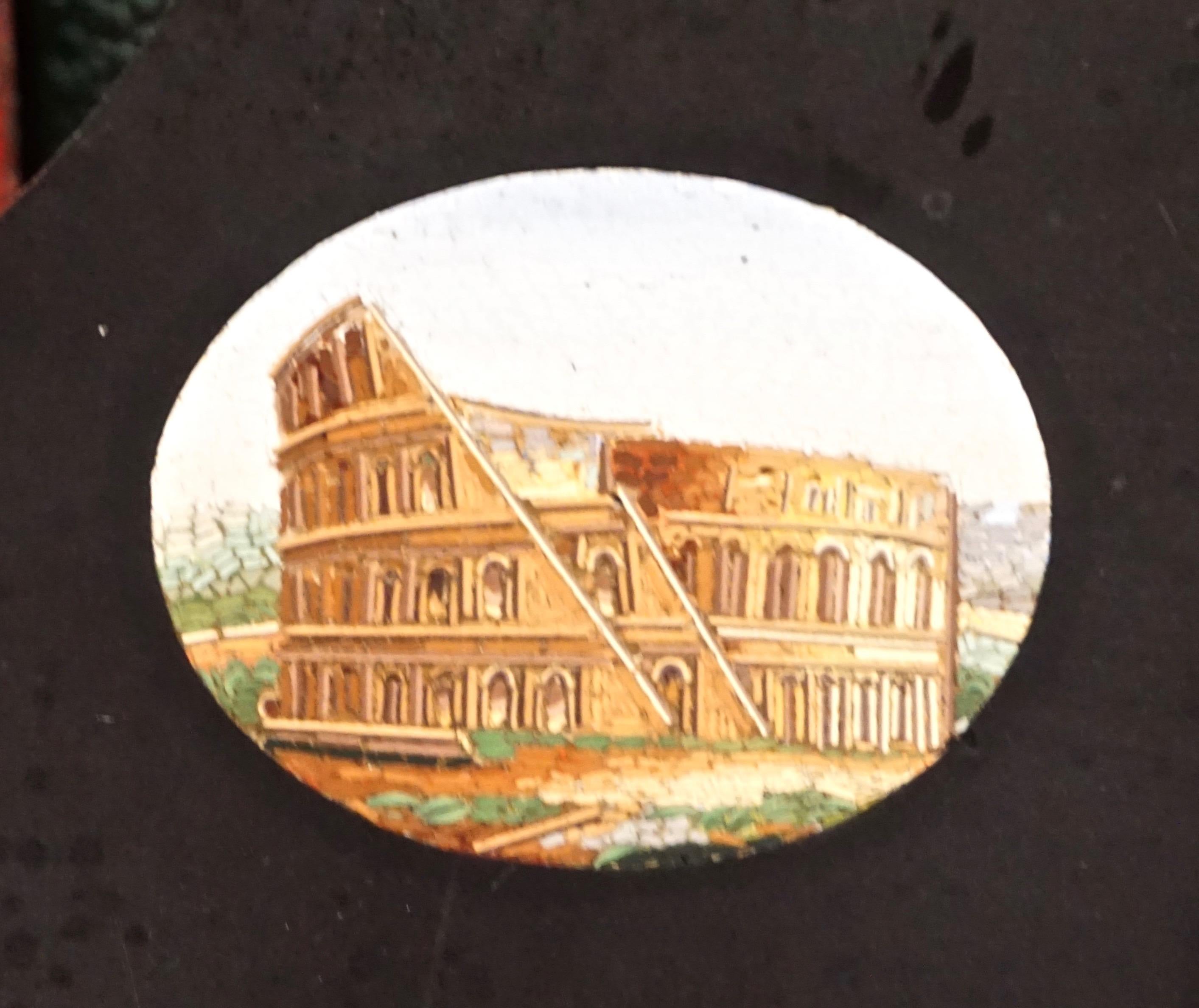 Italian Grand Tour black slate paperweight inset with 5 micro mosaic depictions of ancient Roman monuments. The central medallion of St. Peter's Square is surrounded by the Colosseum, Pantheon, Forum and Temple of Vesta, all intricately crafted of 