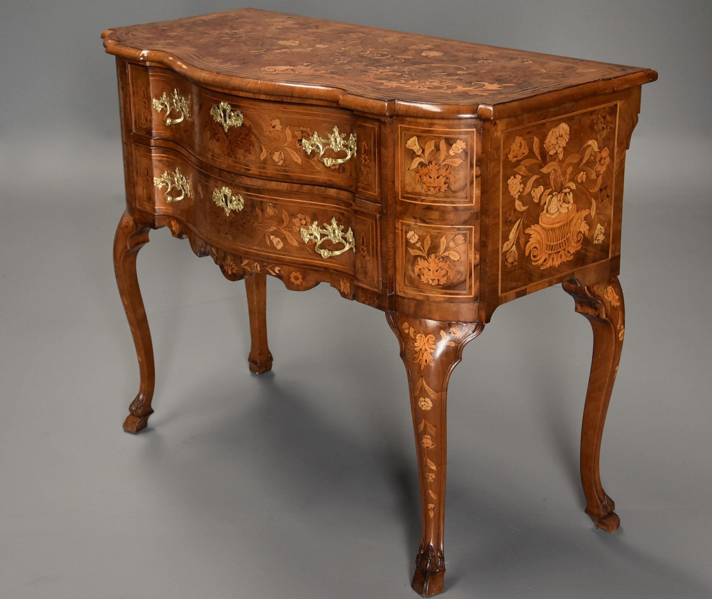 A fine quality mid-19th century floral marquetry walnut lowboy (or chest of drawers) of serpentine form.

This decorative piece consists of a burr walnut marquetry veneered serpentine shaped top inlaid with various woods including central urn with