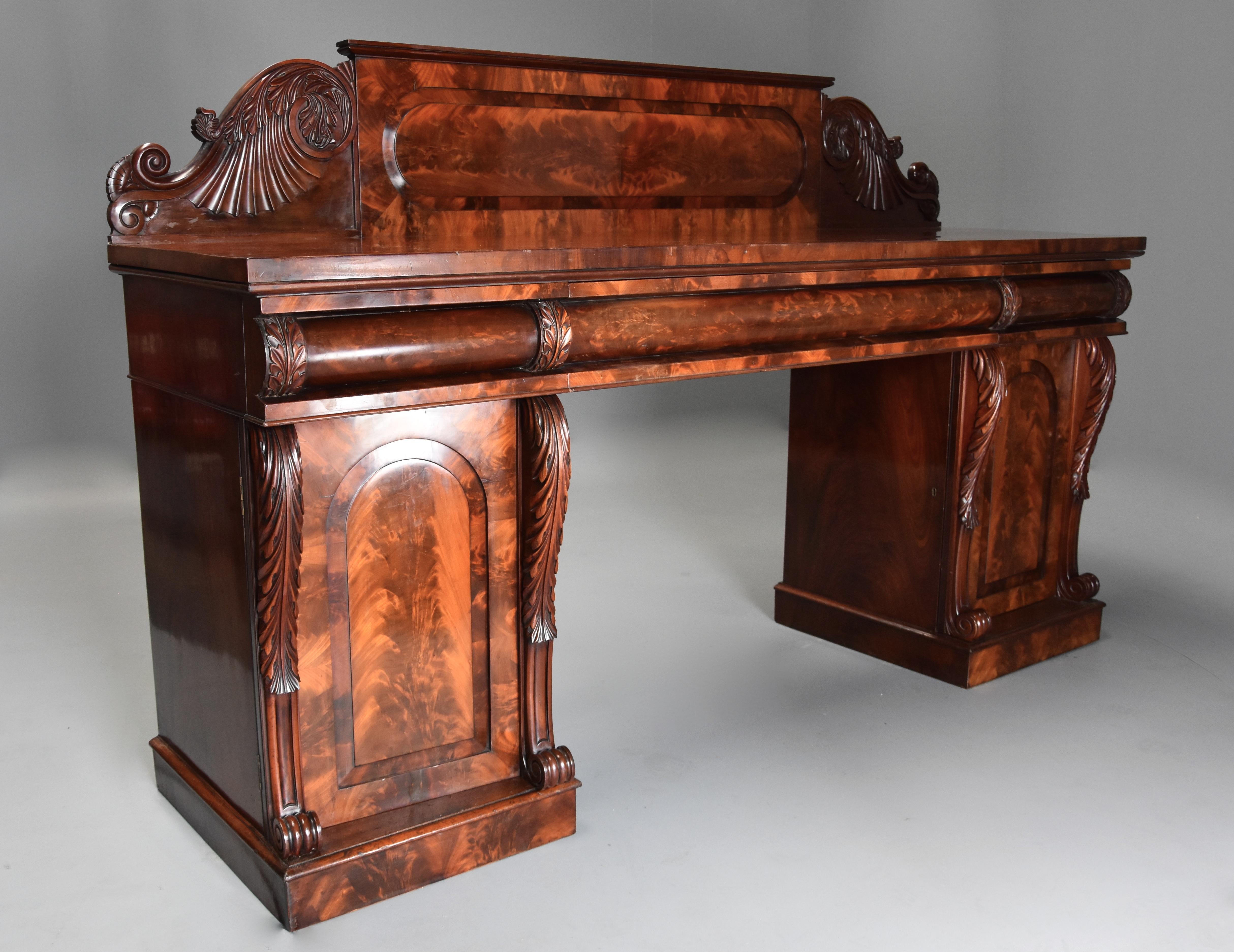 A fine quality mid-19th century (circa 1840) mahogany pedestal sideboard with superb flame mahogany veneers.

This sideboard consists of an upstand of superb quality flame mahogany veneer with recessed oblong panel with rounded ends with finely