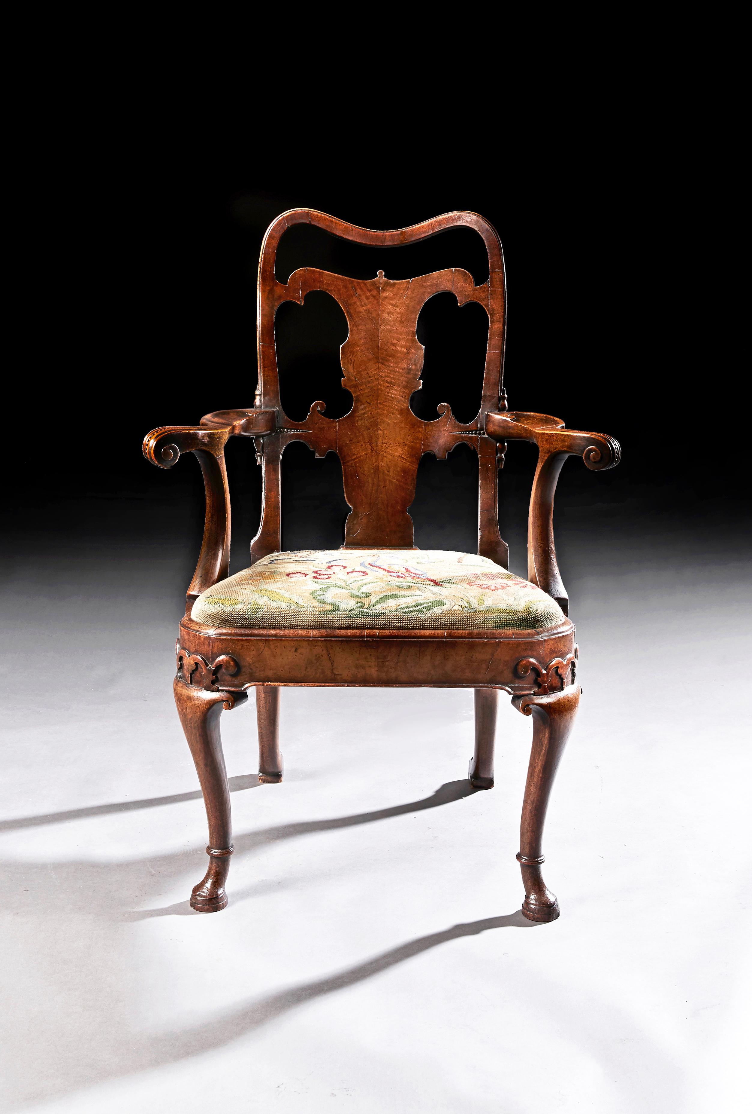 A very fine quality mid-19th century walnut open armchair,

English, circa 1860.

Of early Georgian design having a pierced back and solid shaped splat popularised by the likes of Giles Grendy in the George II era whilst unusually having a