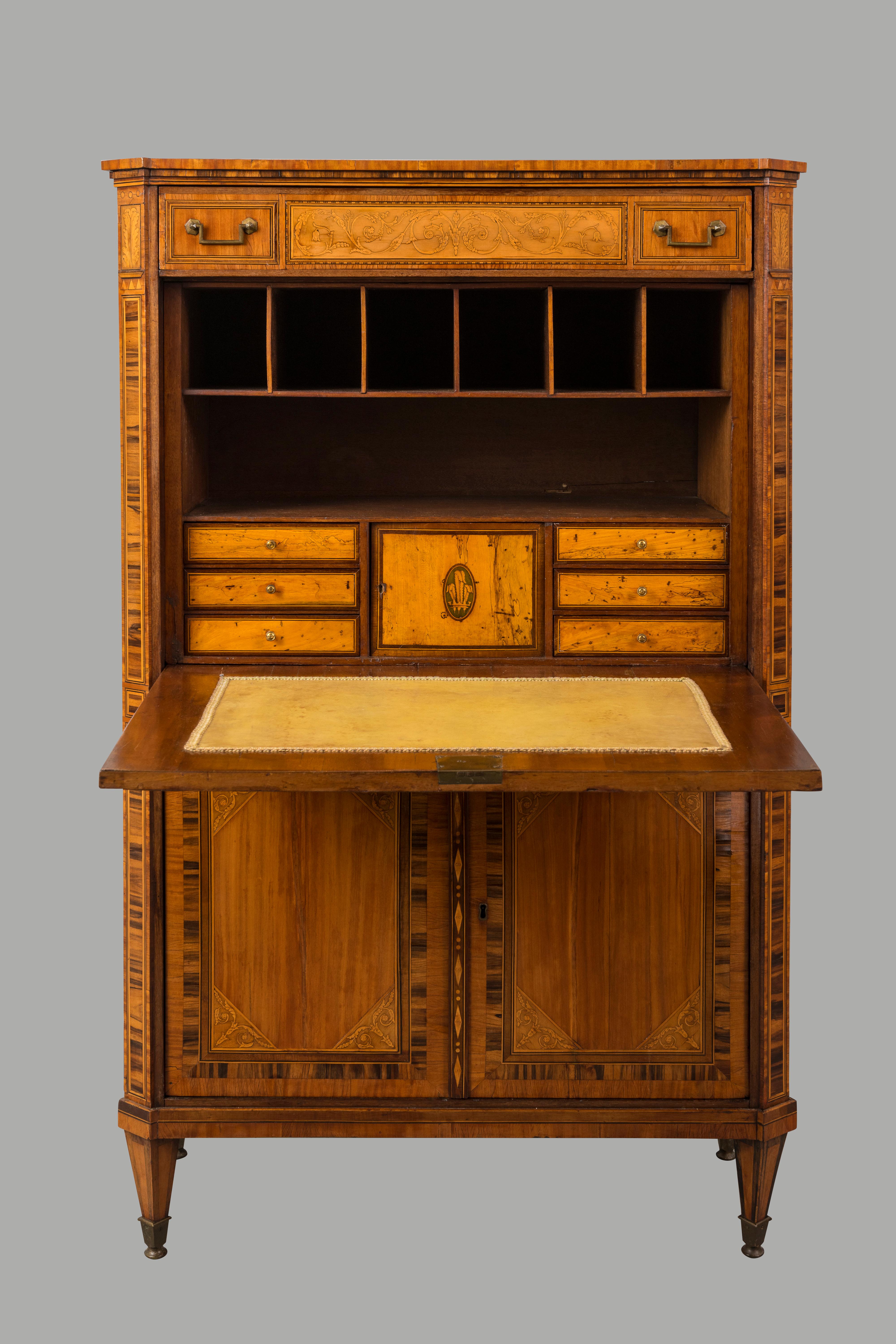 A fine Dutch neoclassical inlaid satinwood secretaire abattant on square tapered legs with inlays of rosewood, tulipwood and boxwood, the front opening to reveal a counterweighted writing surface  lined with pale green leather. The interior is