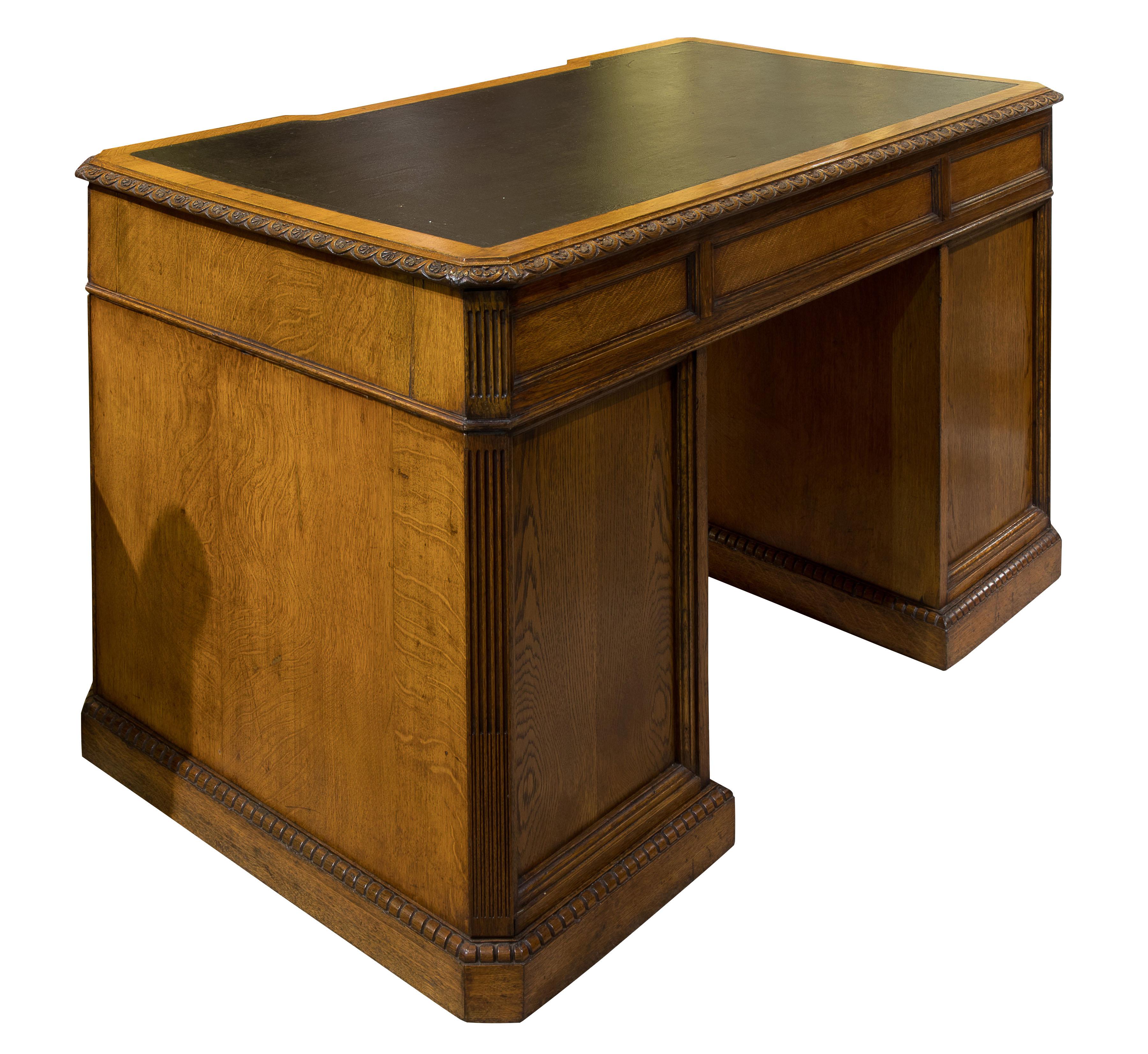 A very fine quality oak pedestal desk. The top moulding carved with rosettes; above nine drawers flanked by canted, stop fluted corners and dentilled plinth carving, panelled to the rear, cedar drawer linings & 'aesthetic' brasses attributable to