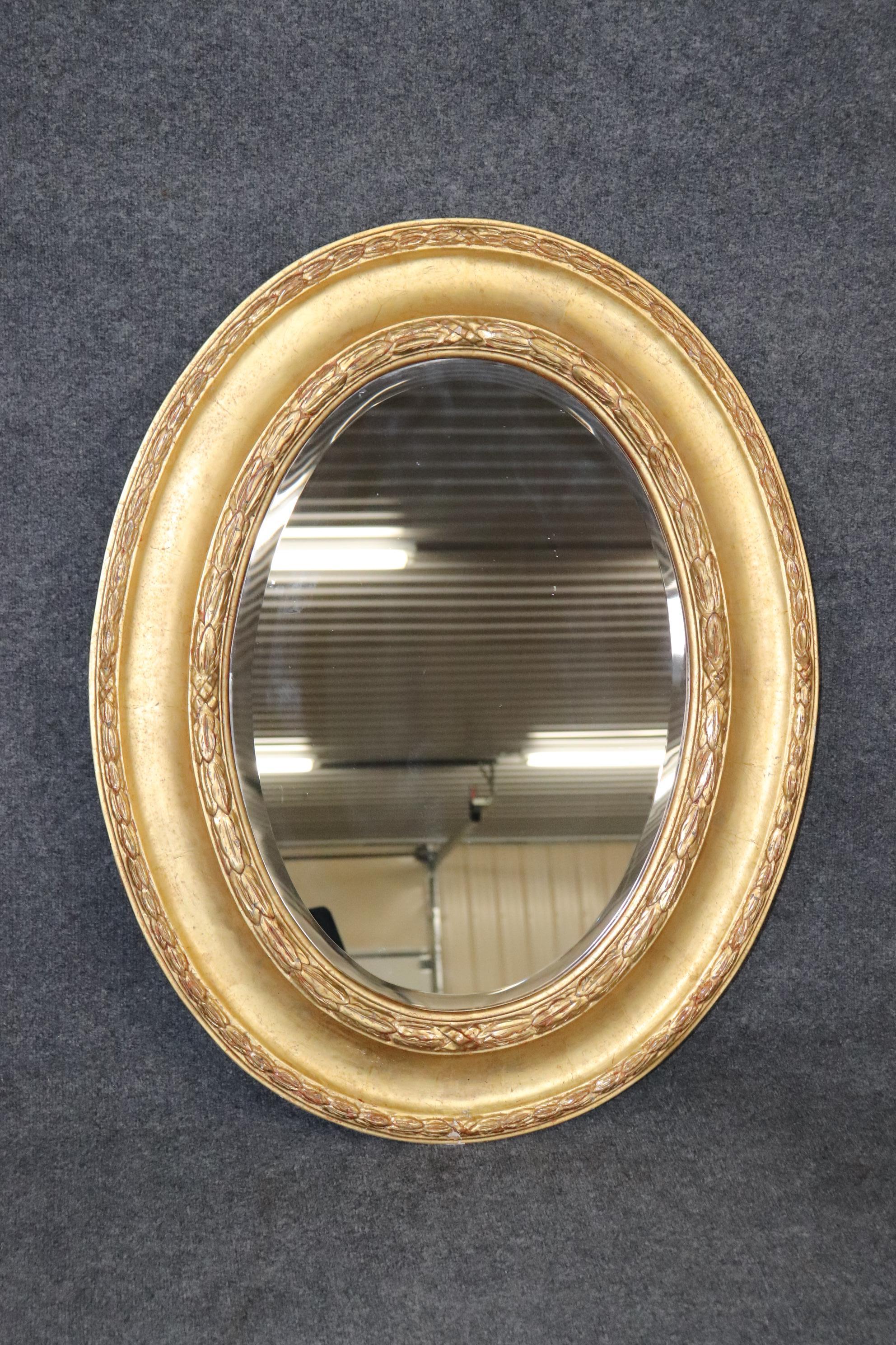 This is a gorgeous mirror because of the finish. Look at the genuine gold leaf finish thats super bright and has hints of Italian red bole clay ground behind the gold leaf. The mirror plate is clean and clear. Can be hung both vertically and