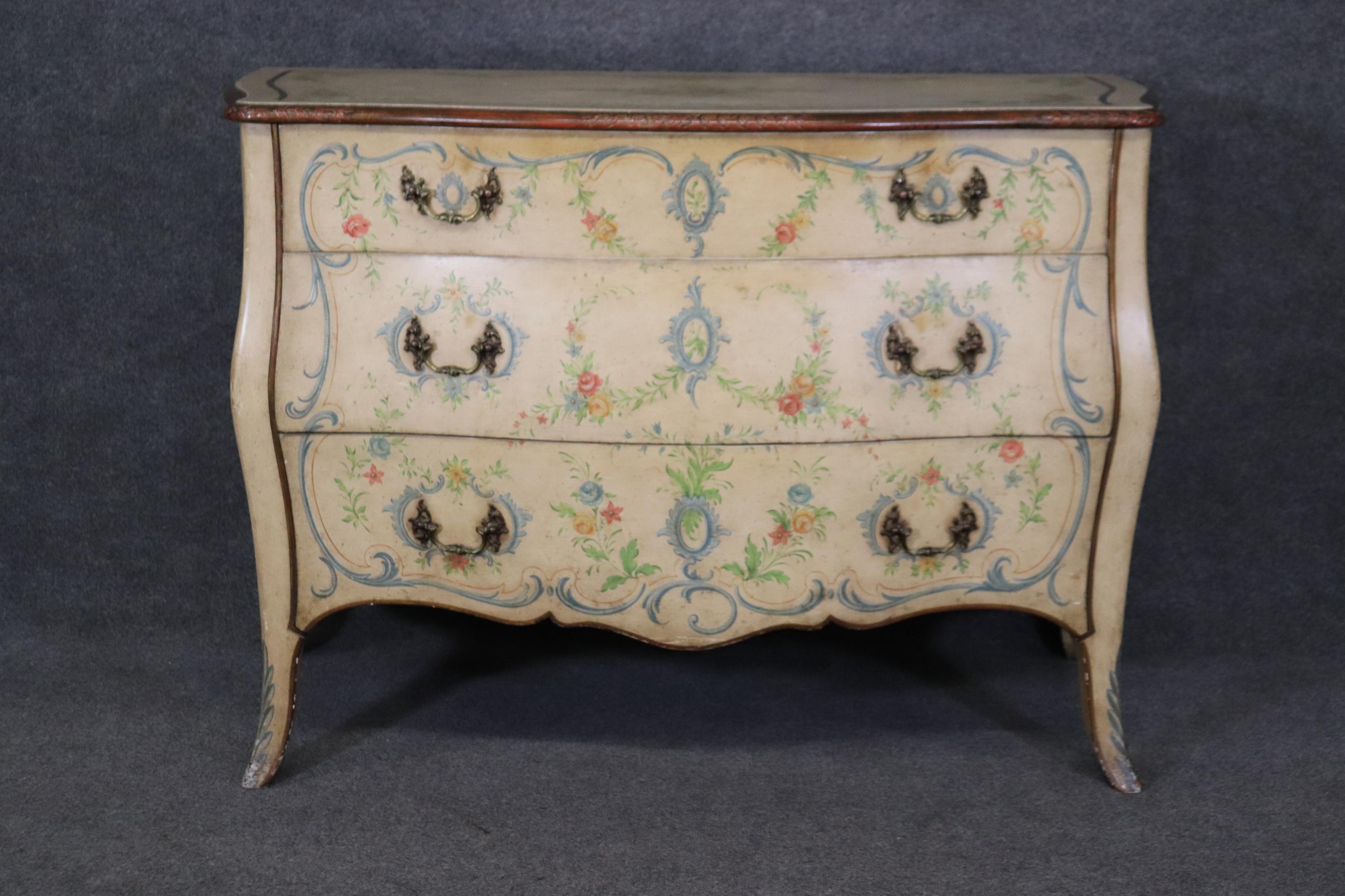 This is a superbly painted and crafted Italian-made Venetian decorated commode or dresser. The dresser features some of the finest paint decorating we've seen in a long time. The edge of the top is carved which is an unusual touch for these kinds of