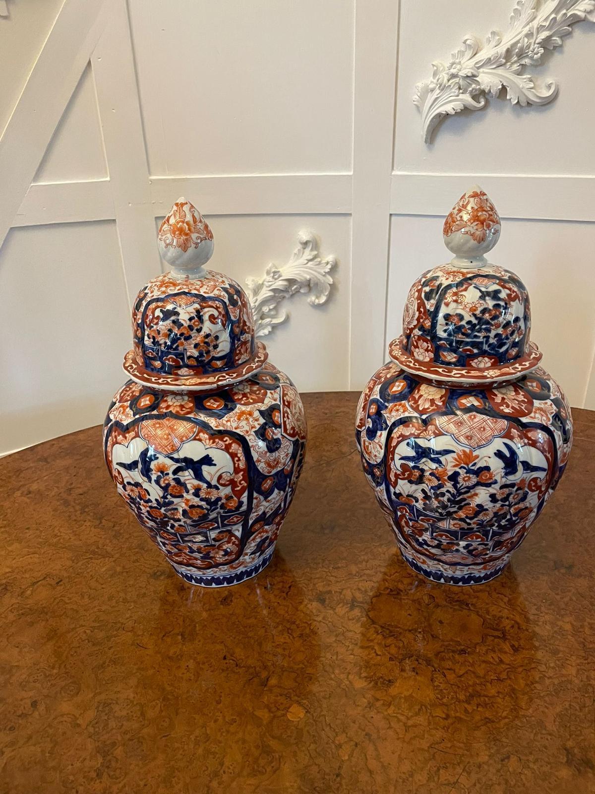 Fine quality pair of antique Japanese Imari lidded vases having quality hand painted Imari vases in wonderful red, blue and white colours with original lids, one has a piece missing to the top of the vase as shown in the pictures, the price reflects