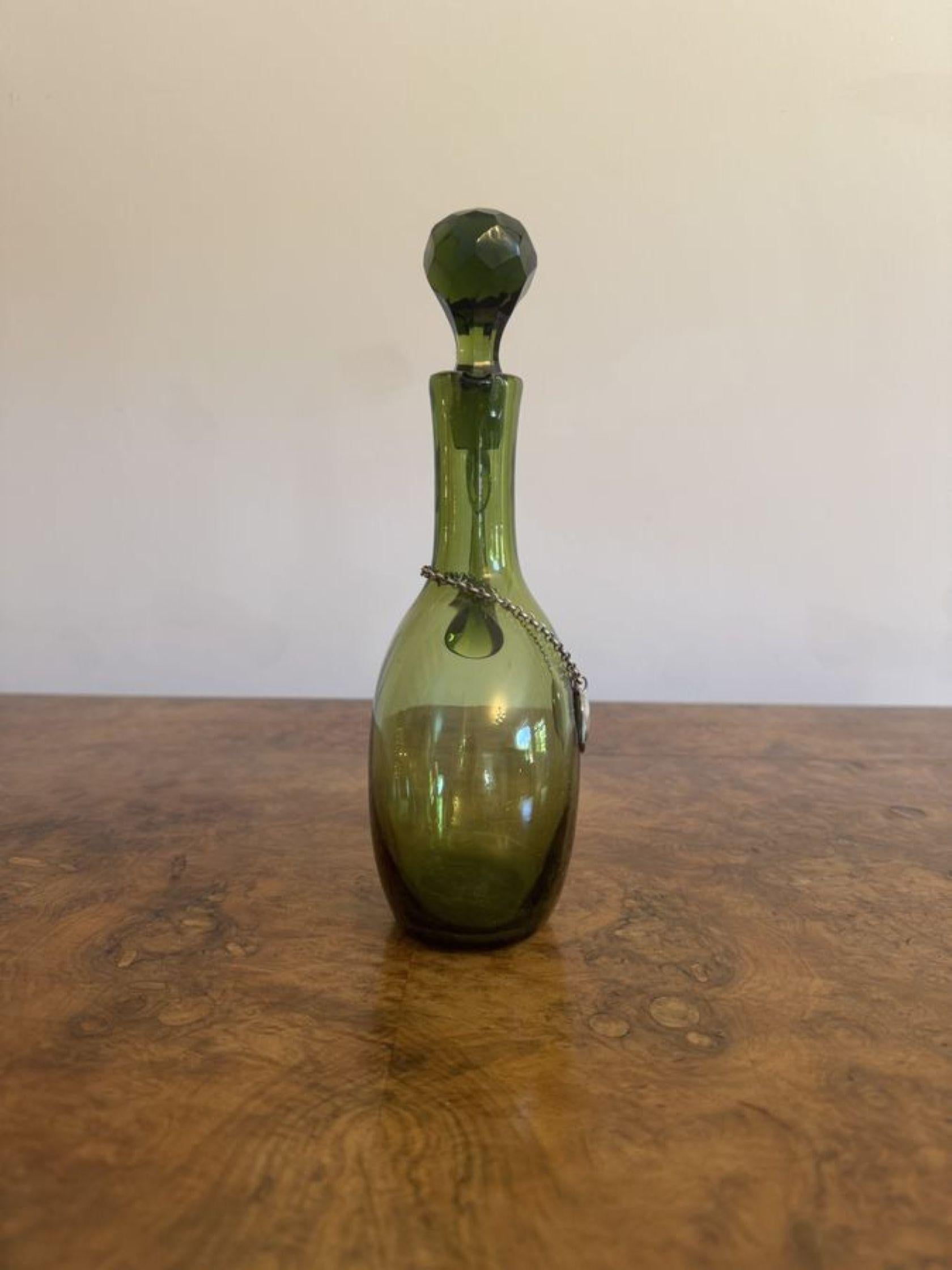 Fine quality pair of antique Victorian green glass spirit decanters with a bulbous shaped body, a shaped handle to the back and the original cut glass stopped both with a silver plated decanter tag inscribed 'Rum' and 'whisky'. 

D. 1840