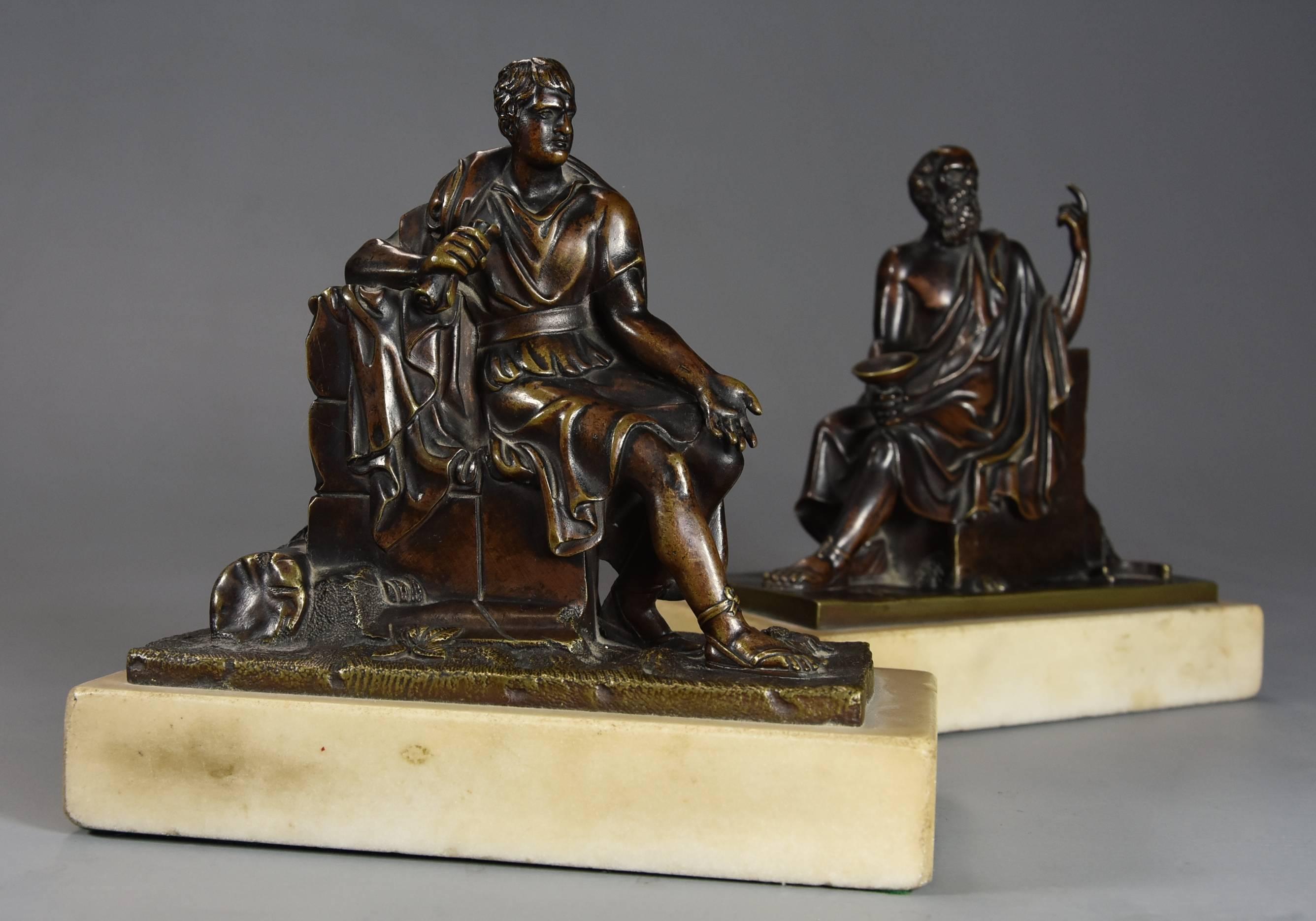 A fine quality pair of late 19th century French bronzes of Socrates and who is believed to be Leon of Salamis with superb patina both supported on Carrara marble plinths.

This pair of bronzes both seated and wearing Classical attire, Socrates