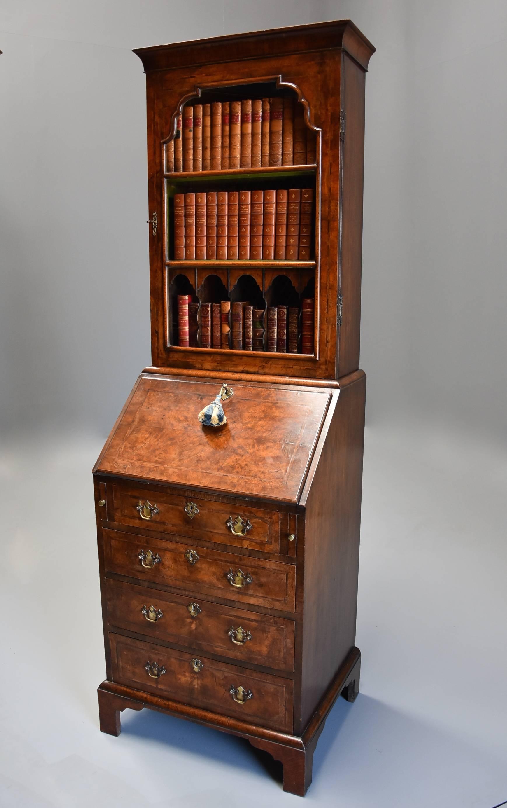 An early 20th century fine quality Queen Anne style walnut bureau bookcase of small proportions and superb patina (colour).

This bureau bookcase consists of a cross grain moulded cornice leading down to a glazed door with key with a shaped