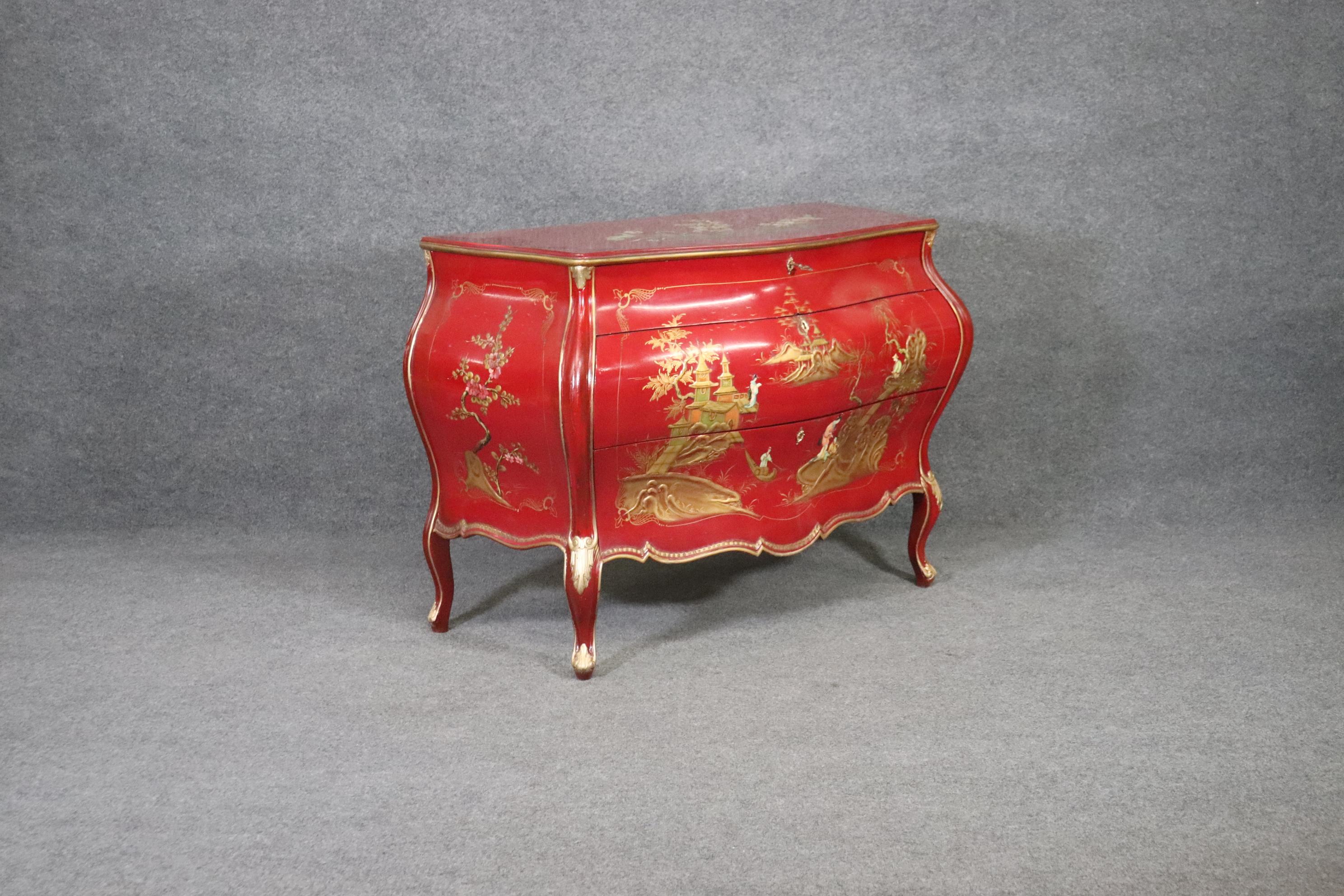 This Chinoiserie red French Louis XVI Style hand painted bombe commode chest of drawers, antique dresser circa 1930 is a stunning and rare style of commode. The hand painted chinoiserie is in very good condition. The red color is very rare as most