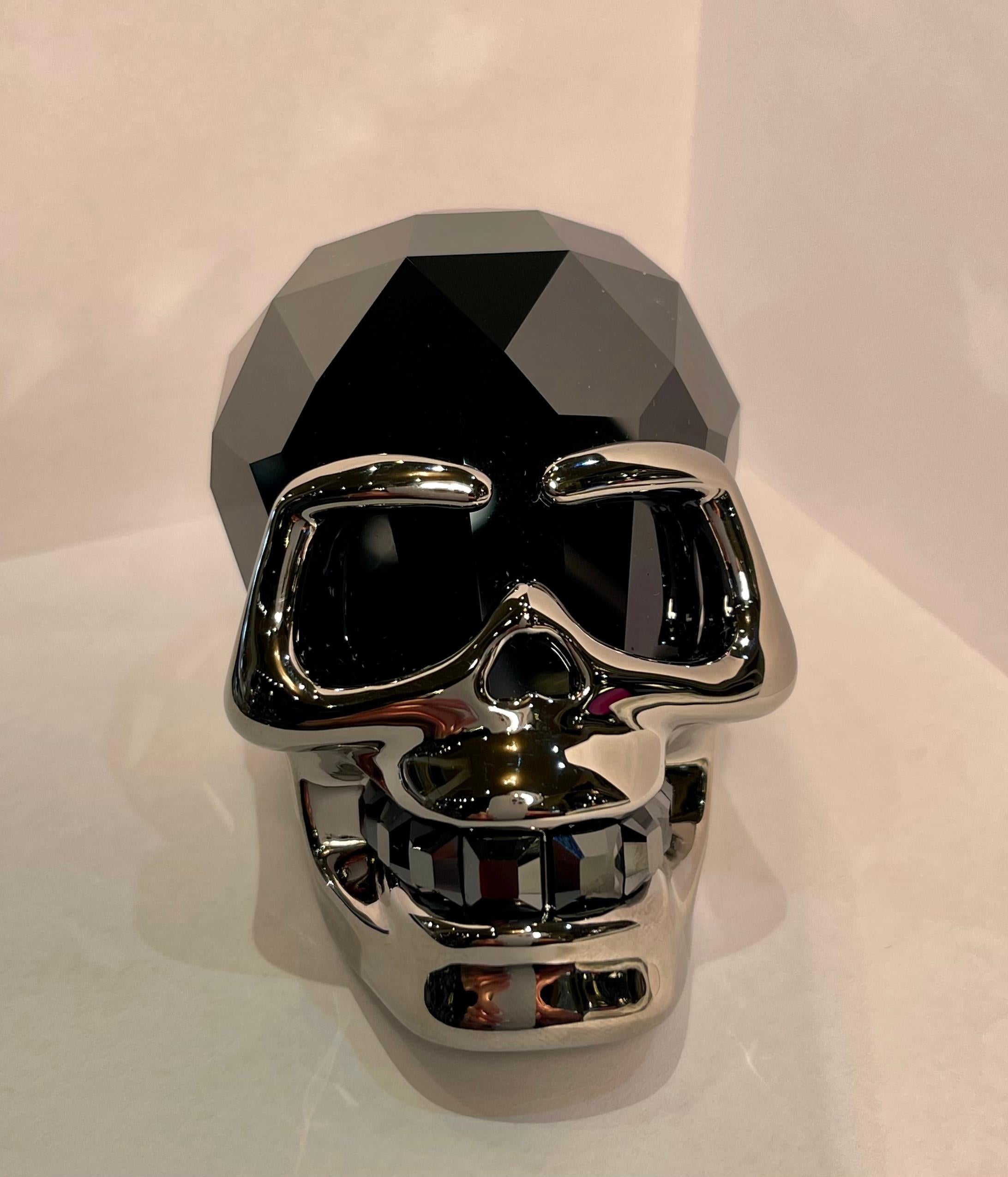 Beautifully and expertly hand made in Austria, finest quality Swarovski Crystal Jet Hematite faceted crystal skull with ruthenium finish metal accents on the face and base. Skull features square faceted hand cut matching faceted crystal teeth. Circa