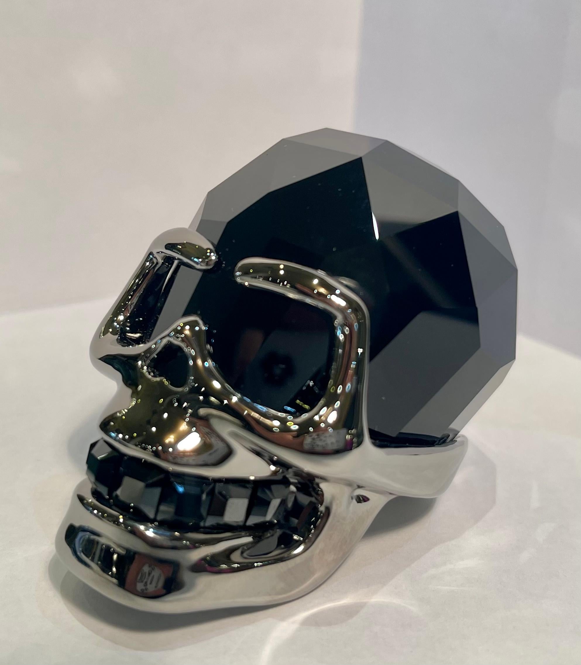 Beautifully and expertly hand made in Austria, finest quality Swarovski Crystal Jet Hematite faceted crystal skull with ruthenium finish metal accents on the face and base. Skull features square faceted hand cut matching faceted crystal teeth. Circa