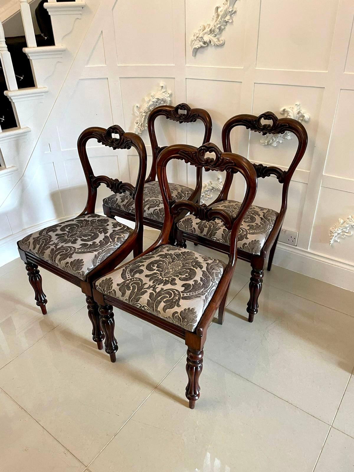 Finest quality set of 4 antique William IV rosewood carved dining chairs having an ornate carved shaped back and carved centre splat. Drop in seats which have been newly reupholstered with quality fabric.  They stand on attractive shaped reeded