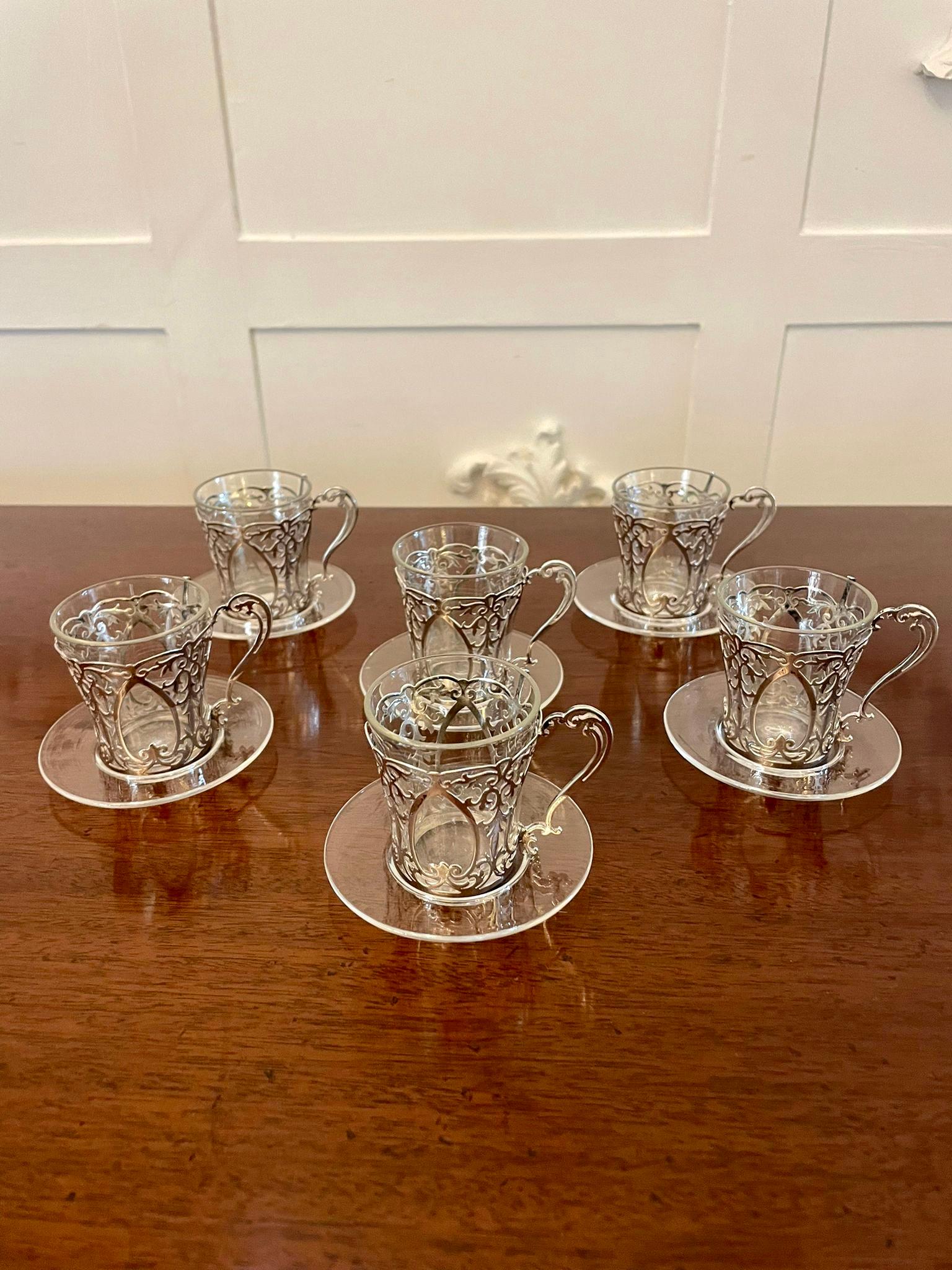 Fine quality set of 6 antique Edwardian solid silver and glass coffee cups
having pretty ornate solid silver coffee cup holders with glass inserts and glass saucers marked with the date 1910, London

An exquisite decorative set beautifully