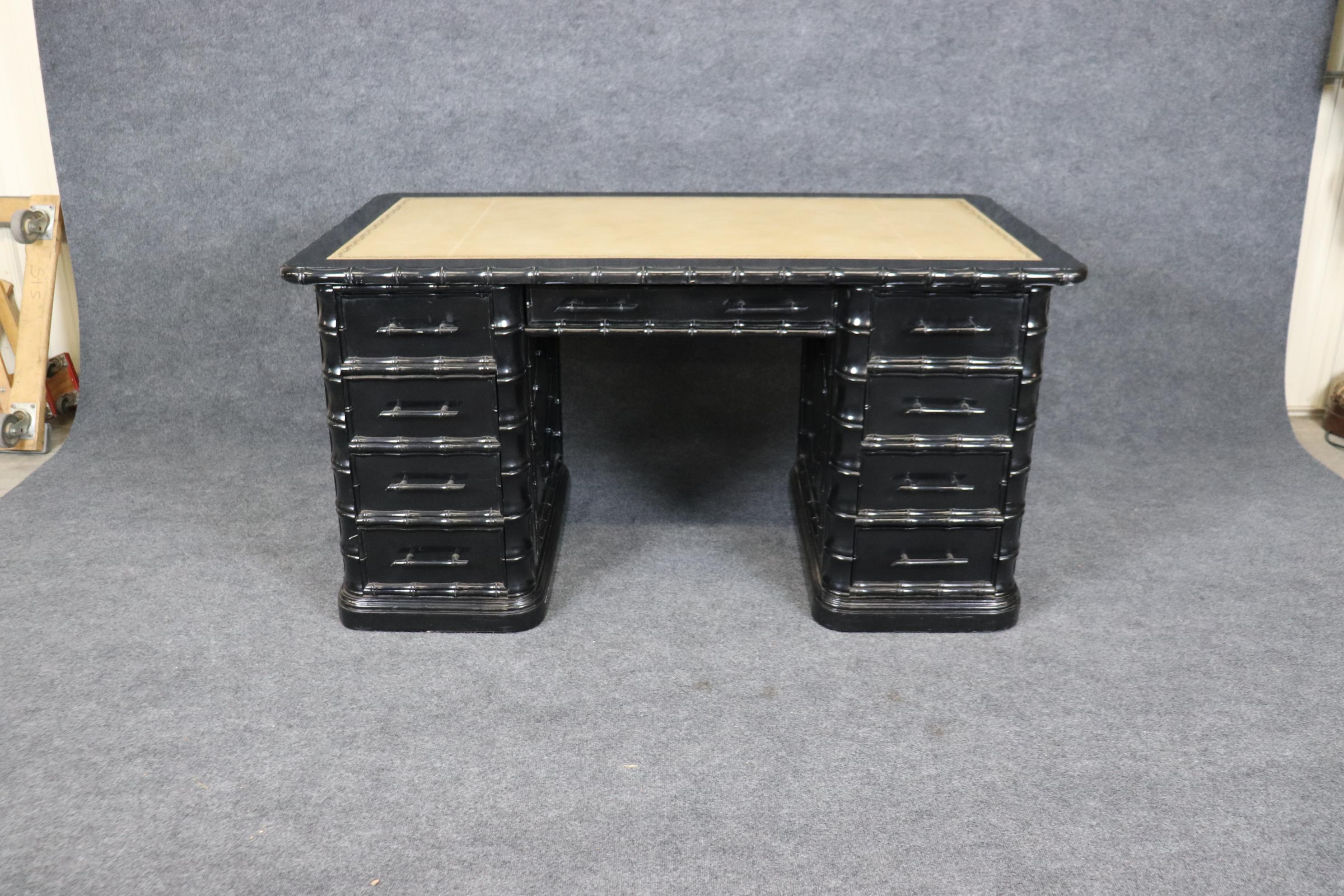 This is a beautiful cabinet-made faux bambook desk in the French or Campaign style. The desk features a fine off-white leather top with gold embossing. The desk comes apart in three pieces. The desk has a nice original black lacquer finish. Measures