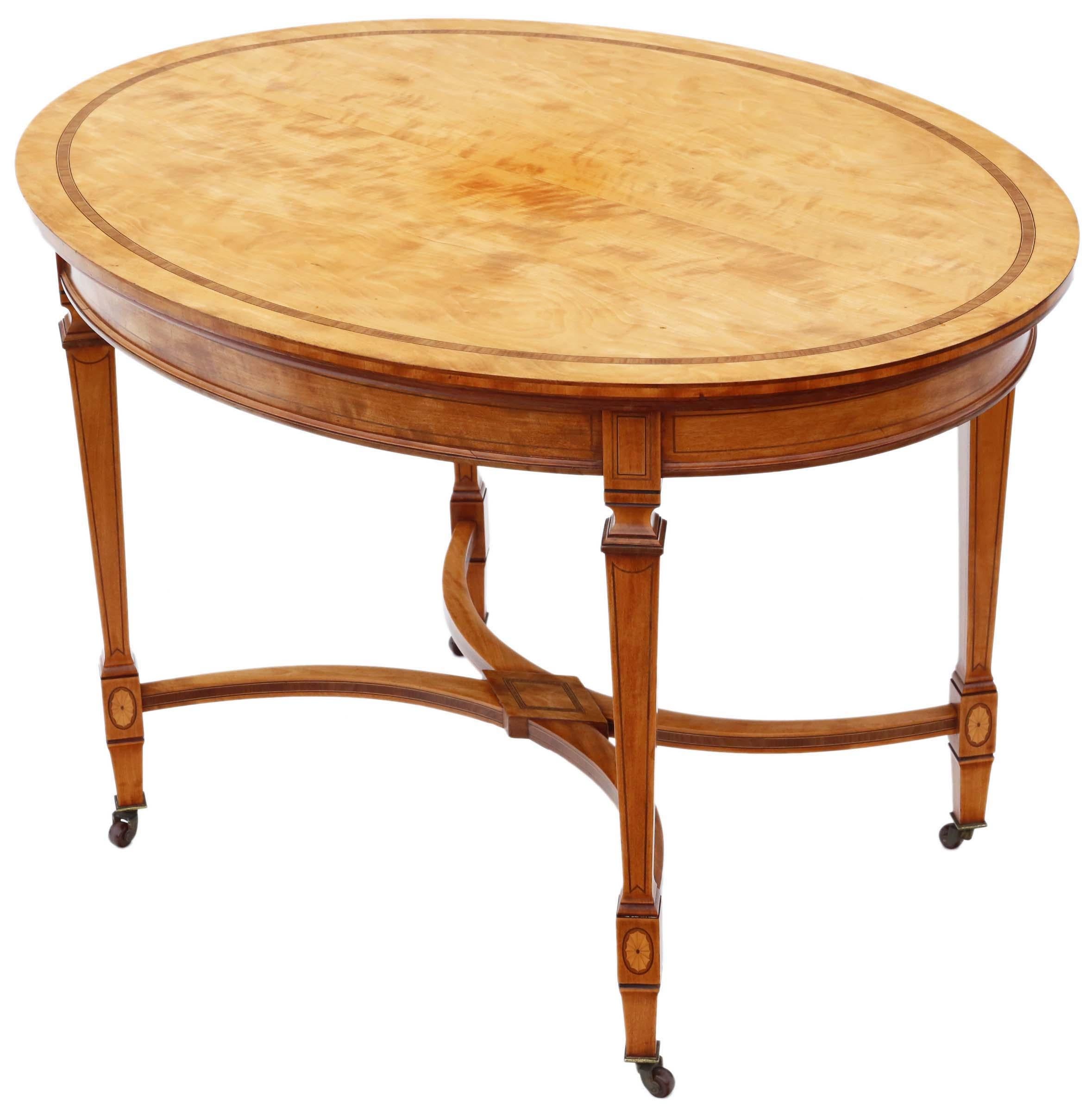 Offering an exquisite Aesthetic Victorian center or breakfast table dating from the late 19th to early 20th century, crafted with fine quality inlaid satinwood. This sturdy piece, with no loose joints, stands gracefully on period castors and