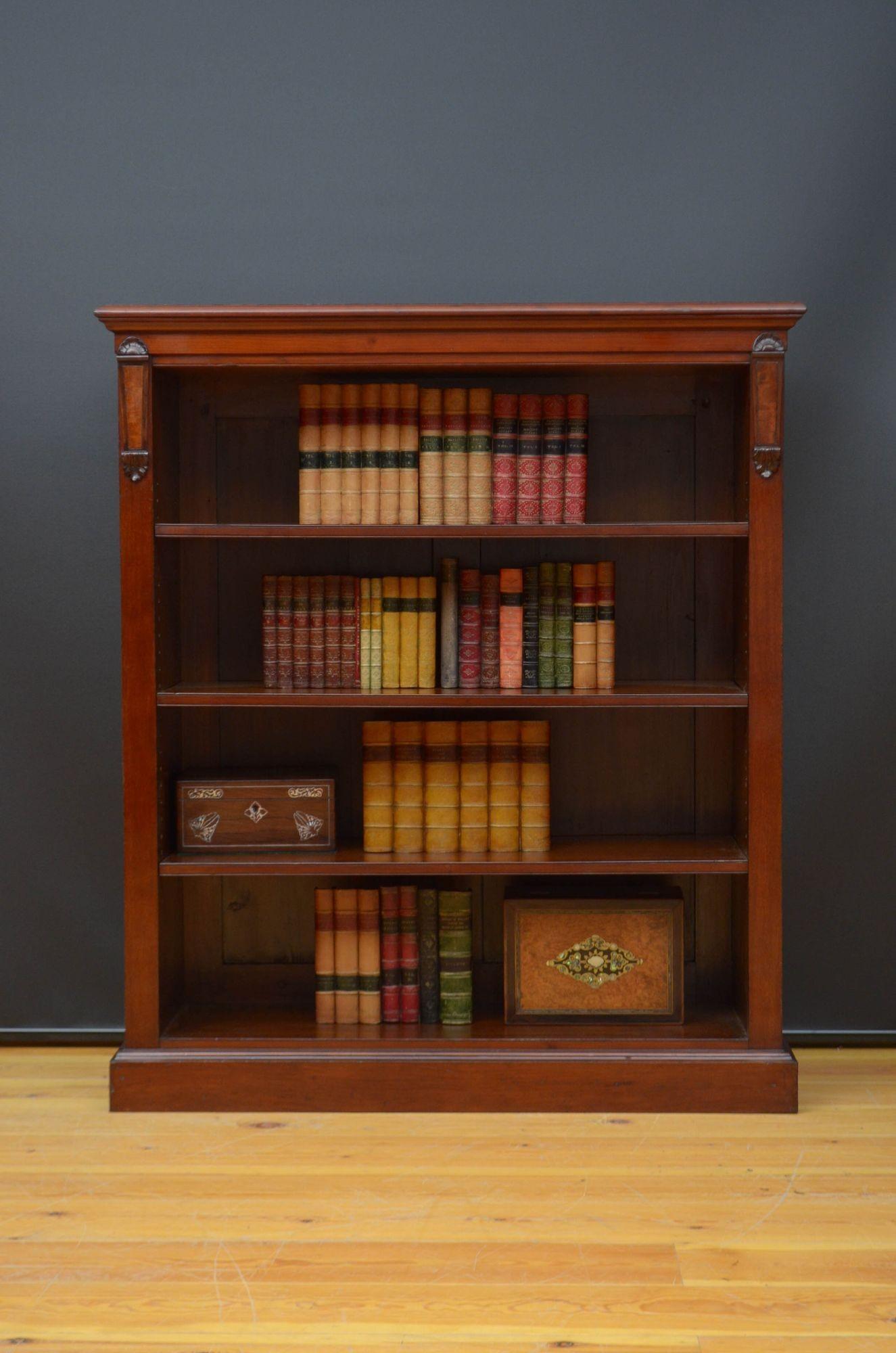 Sn5464 Fine quality Victorian figured mahogany open bookcase, having well figured oversailing top with moulded edge above a shallow frieze and three height adjustable shelves all flanked by drop carvings, all standing on plinth base. This antique