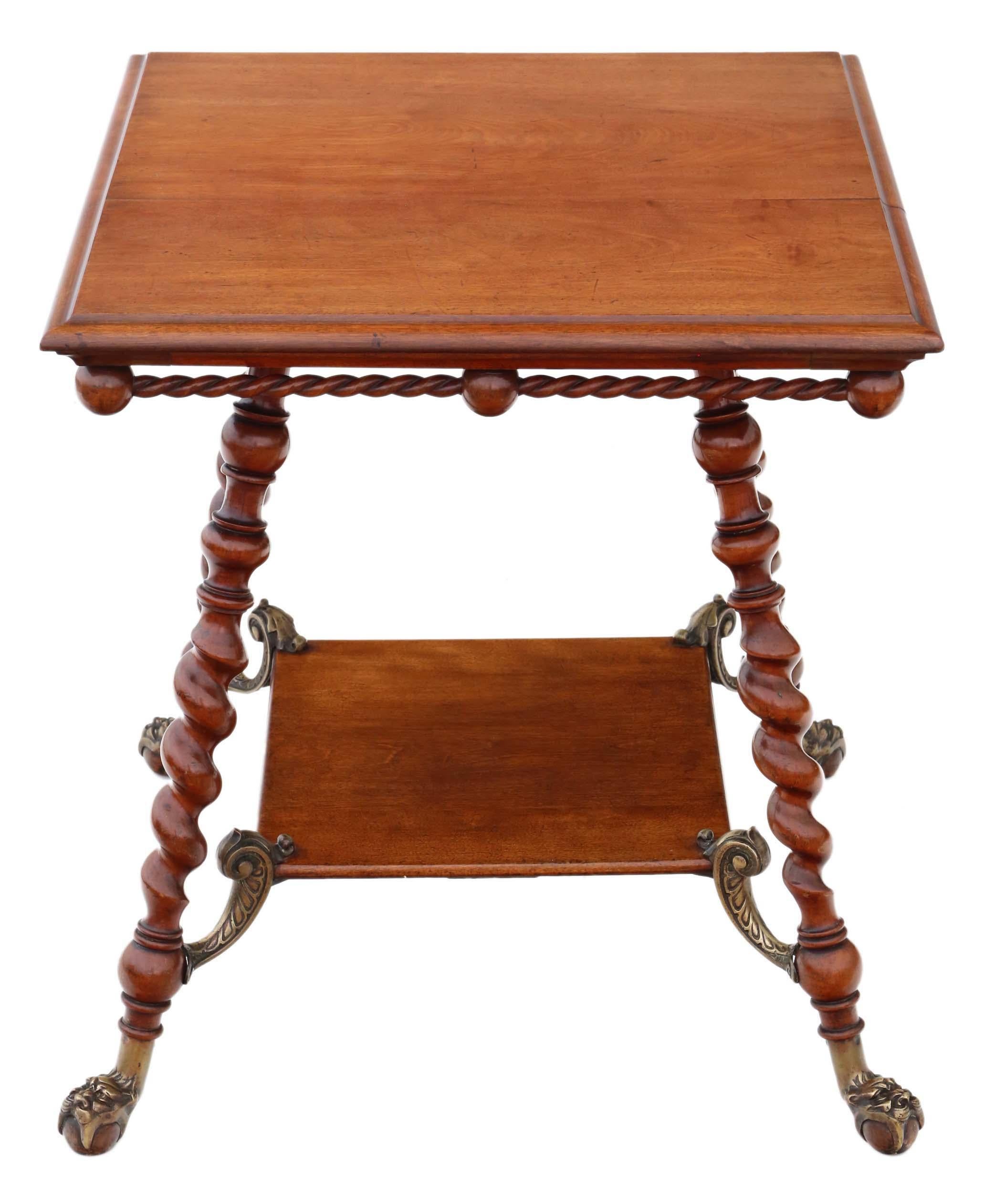 Antique and exceptionally rare Victorian center table dating from around 1880-1900, finely crafted from red walnut and adorned with brass accents.

This table is both solid and weighty, exhibiting no loose joints. It features attractive twist legs