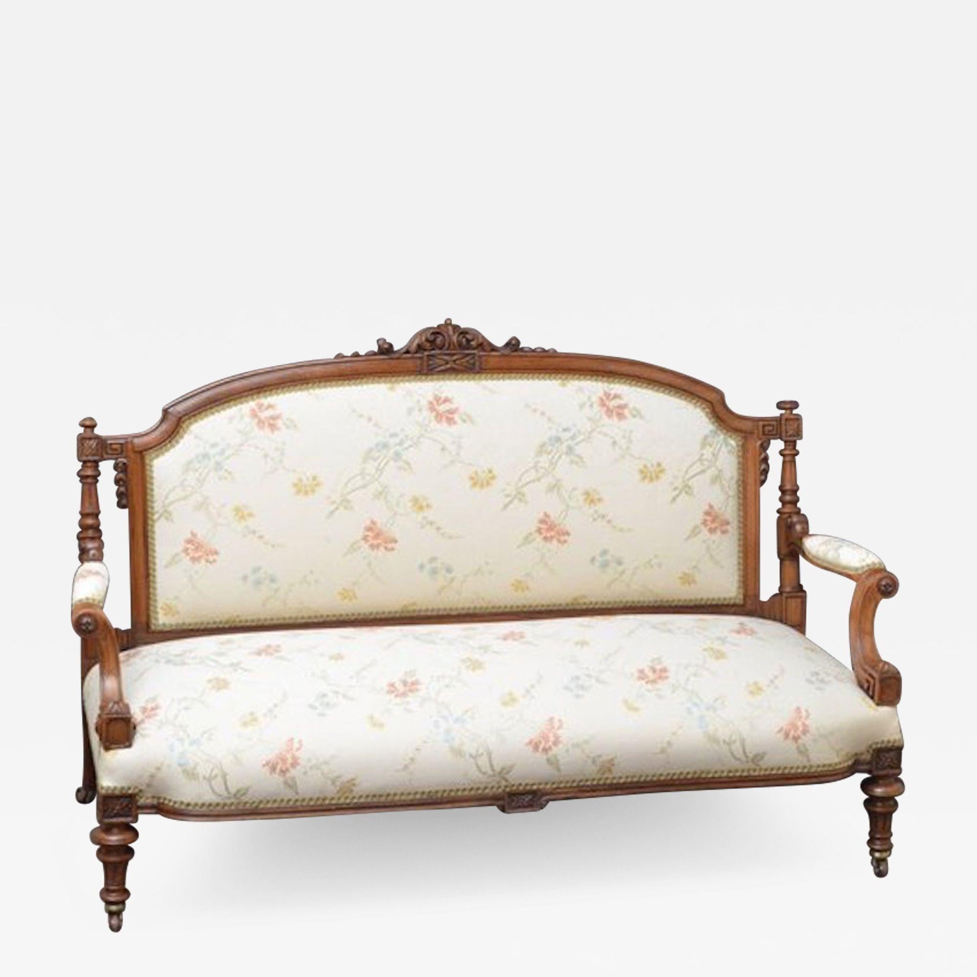 Sn3818 Fine quality, substantial Victorian sofa in walnut, having elegant shaped back with scrolling foliate carving, flanked by fluted columns and intricate detailing, above scrolled open arms and turned and fluted legs terminating in brass