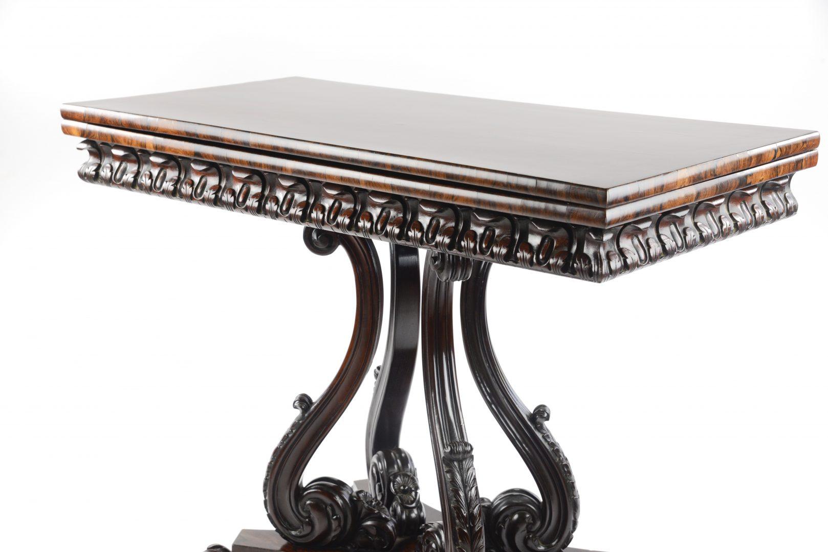 Fine quality William IV rosewood card table, attributed to Gillows, the rectangular top on an extensively carved base with four scroll supports and lions paw feet.

Gillows of Lancaster and London, also known as Gillow & Co., was an English
