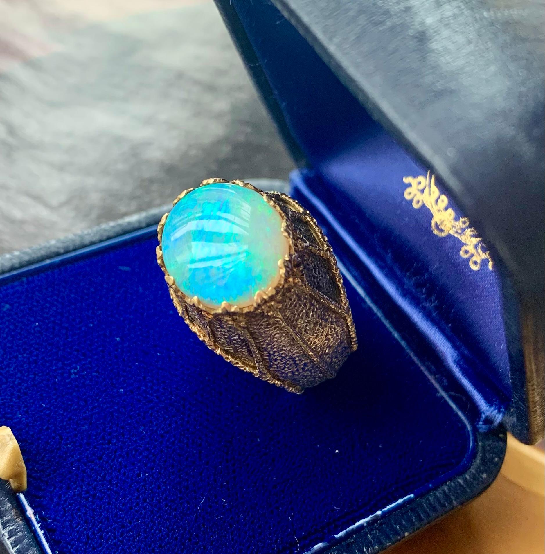 Stunning estate Mario Buccellati High Jewelry cabochon opal 18K yellow and patinated white gold spider web cocktail ring
Mid 20th Century
The large cabochon opal displaying a striking array of colors ranging from turquoise, blue, pink and gold with