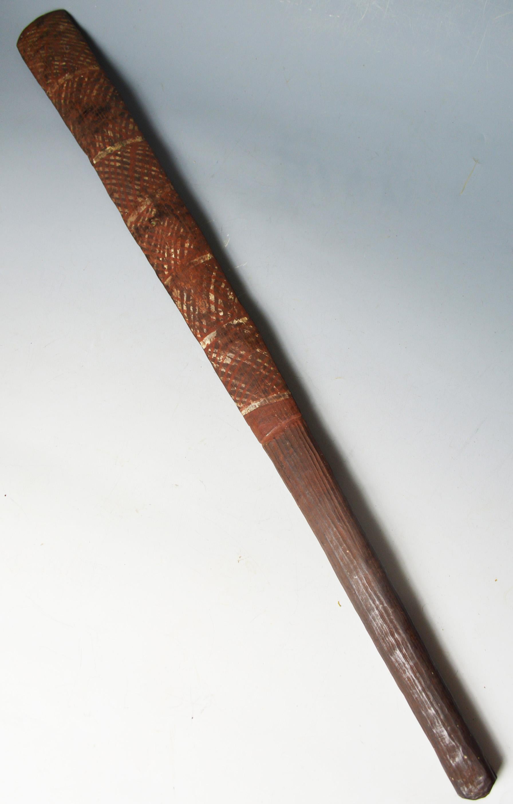 Fine rare old Aboriginal Tiwi Islands ceremonial paddle club
The very finely carved club in hard dark wood with fluted shaft and slender elongated blade resembling a paddle,
painted with circular designs and linear patterns on the front and back,