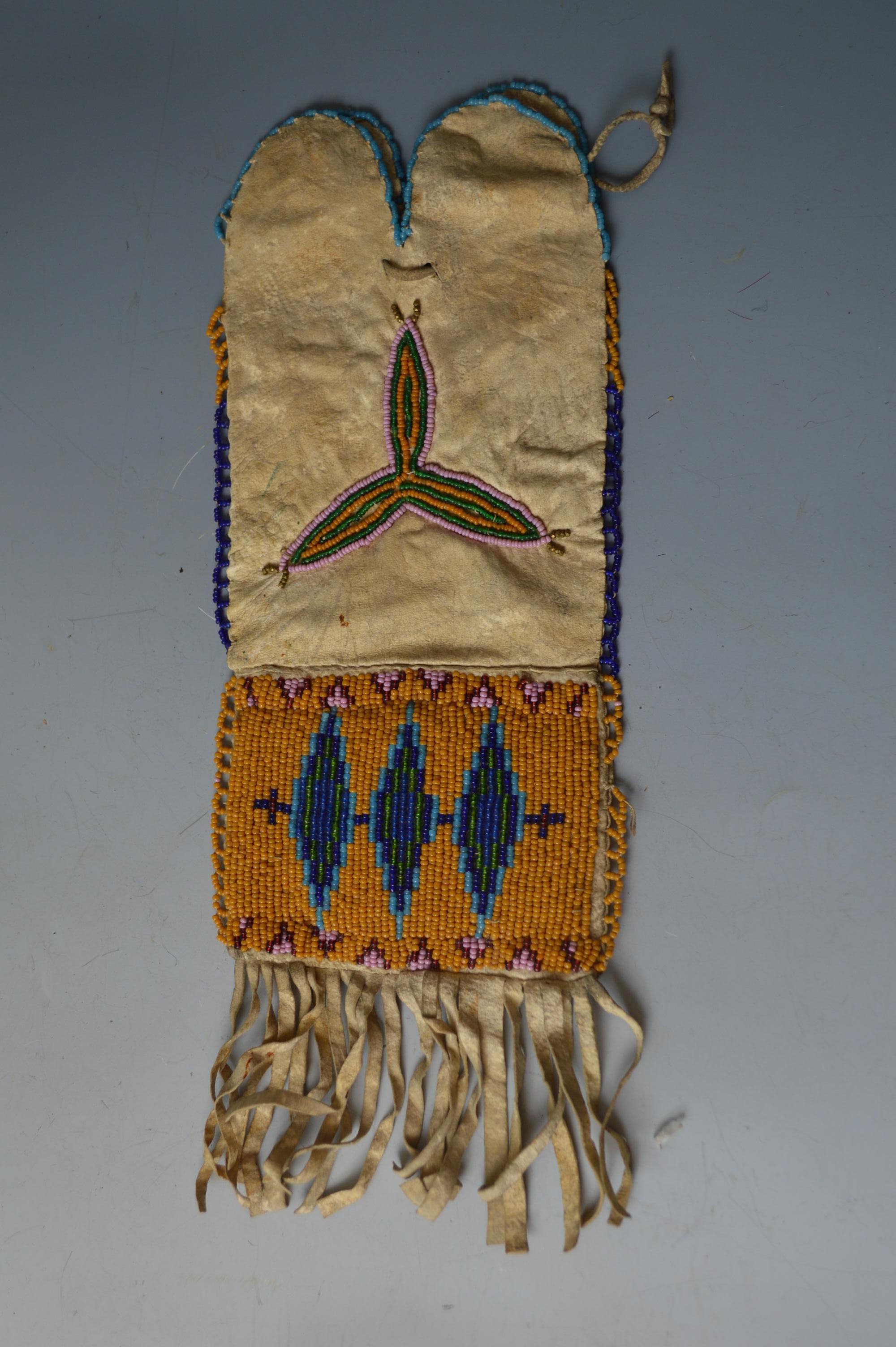 Fine rare old native American beaded pipe or tobacco bag
Buckskin, finely beaded on the both sides with glass beads in floral and geometric designs,
Possibly Apache or Plateau
Measures: Height 30 cm
Period: Late 19th century-early 20th