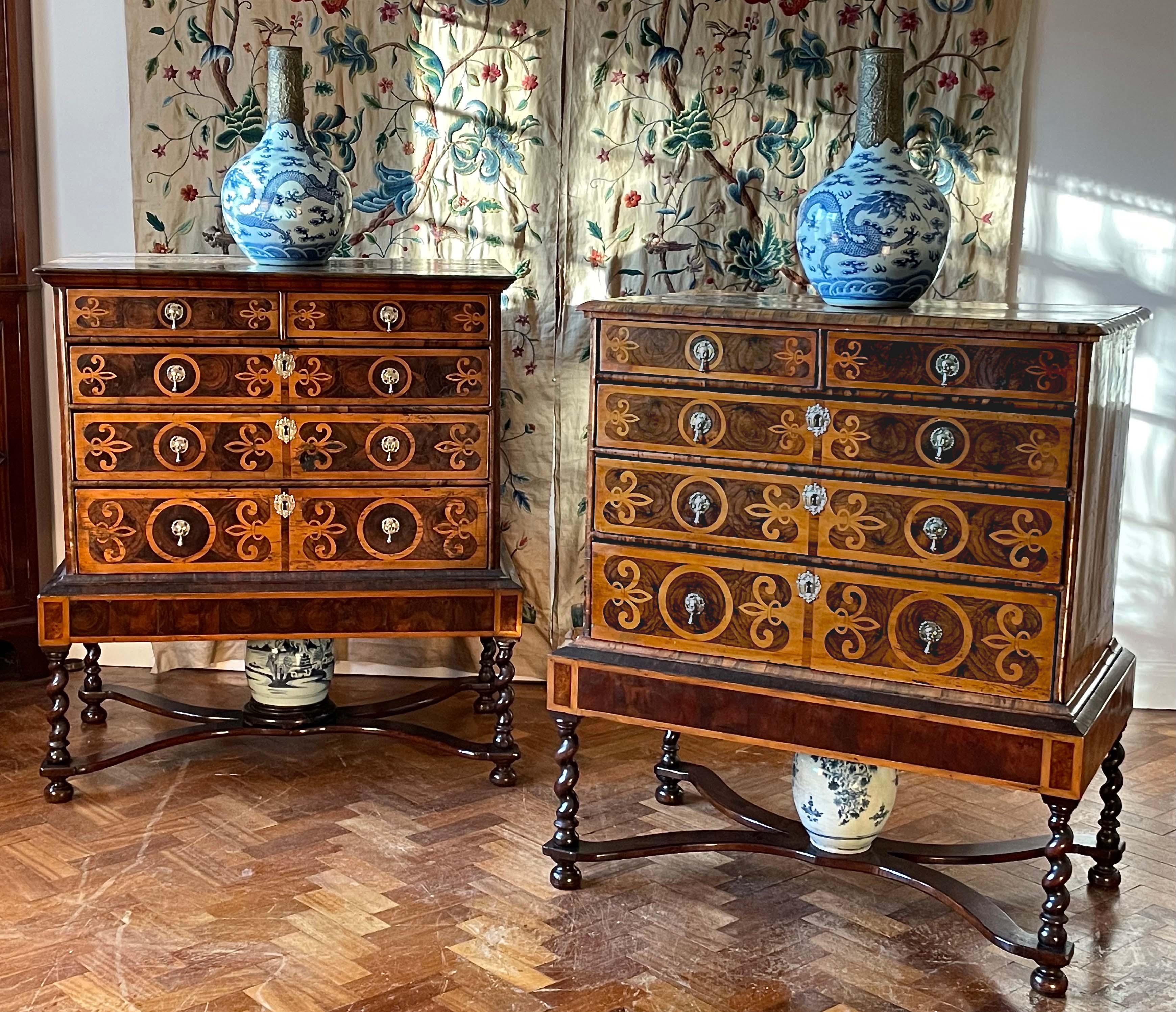 A fine, and rare, very closely-matched pair of late-17th century oyster walnut chests on stands. 
English, Charles II period, ca 1685.

Both with fleur-de-lys inlays bordered by holly bands. 
Superb colour and old patina throughout.
Stands restored.