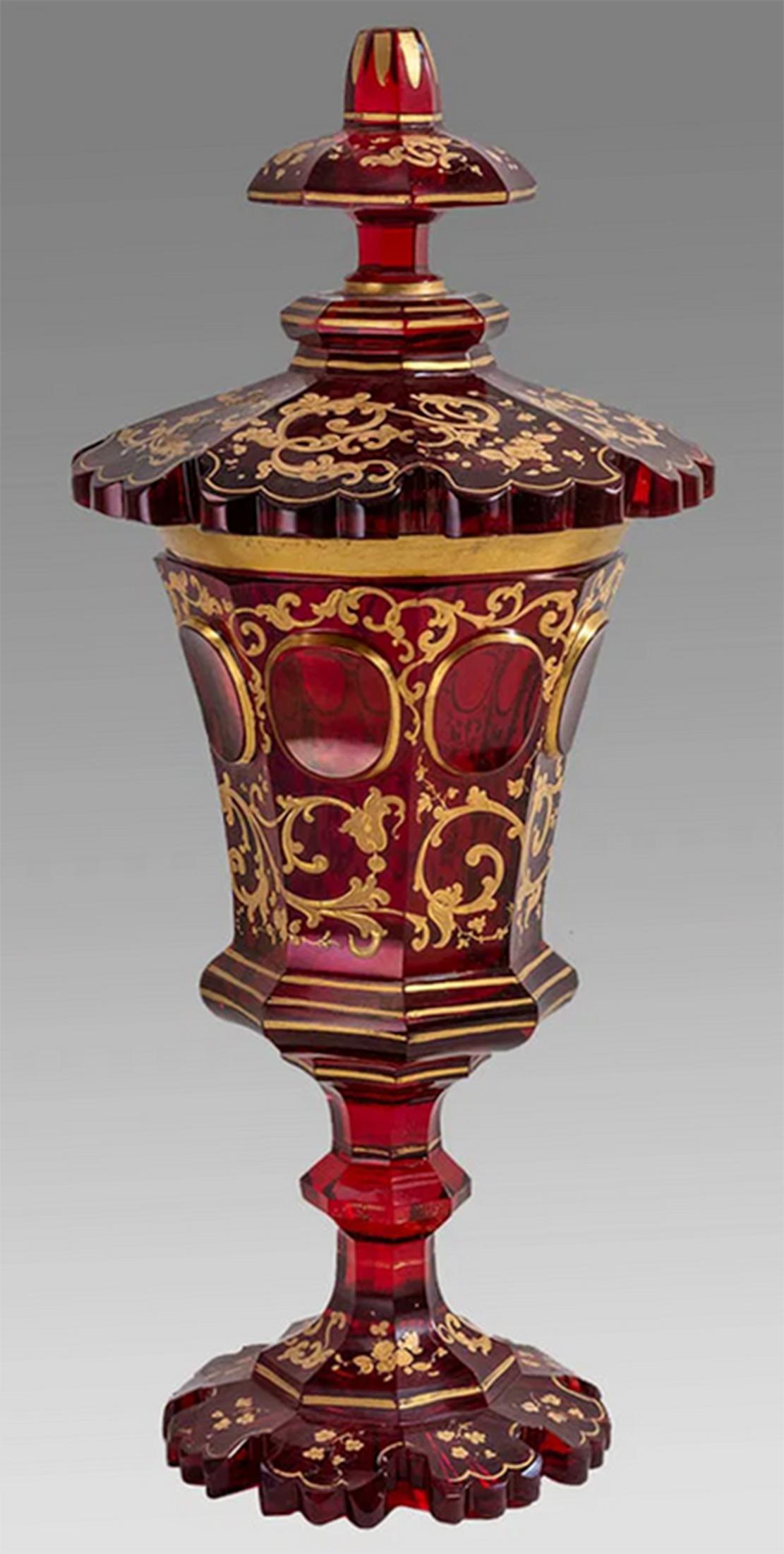 Fine Red & Gilt Painted Bohemian Glass Covered Pokal

Large 19 century Bohemian red glass pokal cup and lid heavily decorated with hand painted burnished gold gilt scroll form ornamentation. 

Late 19th Century 

Bohemia - Modern day Czech