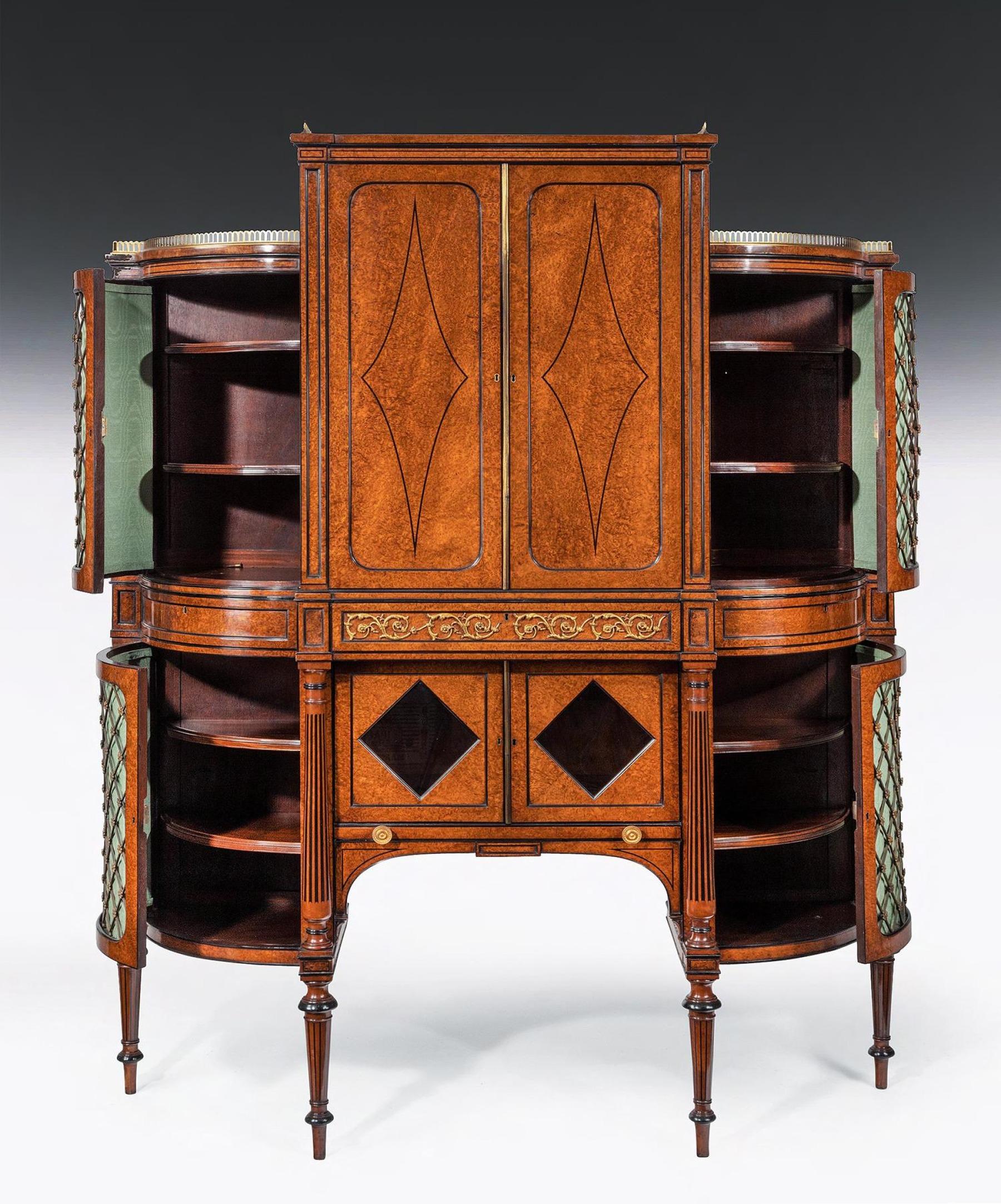 Of outstanding quality, an early 19th Century Regency ormolu mounted amboyna and ebony shaped side cabinet on tapering legs 



English circa 1810.



Finely decorated with ebony beading and stringing, the raised upper section with a pierced brass