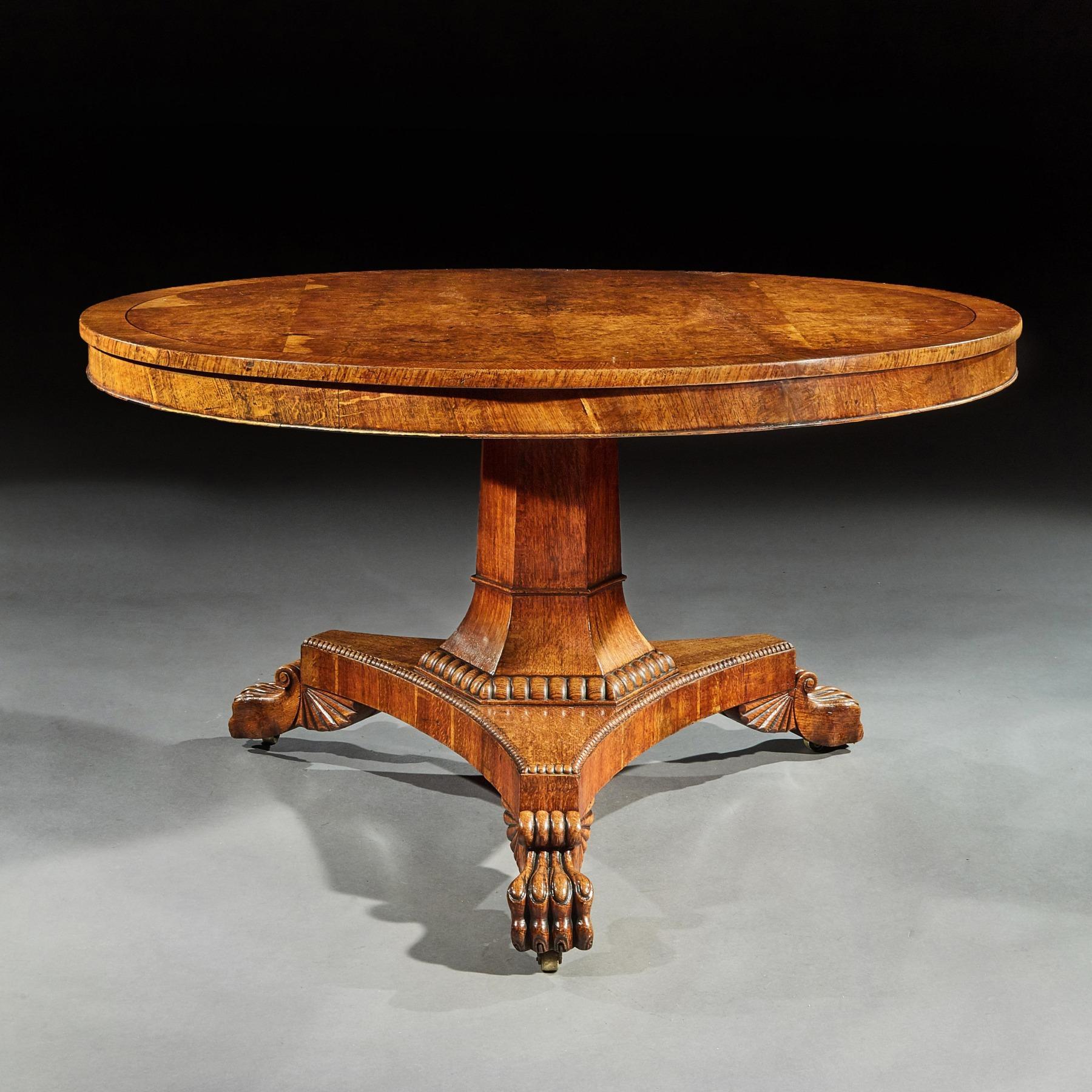 A wonderful Regency burr oak tilt top dining / centre table of excellent natural color and wax patina.

English circa 1825

Constructed during the reign of George IV and inspired by Greco Roman design this superb table has extremely well chosen