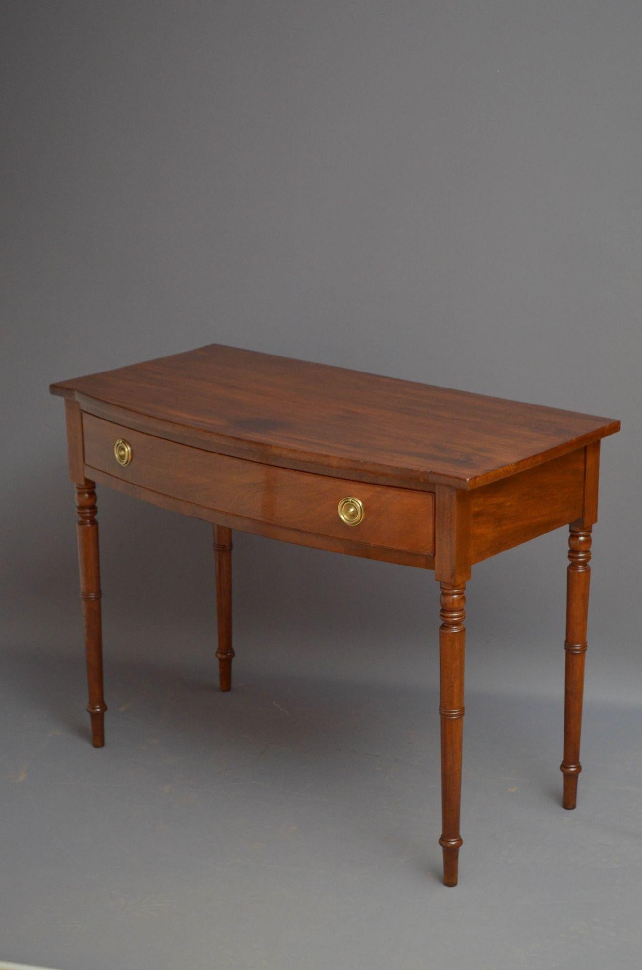 Sn5259 Elegant Regency mahogany dressing table of bow fronted outline, having figured mahogany top and cockbeaded drawer fitted with brass handles, standing on turned and ringed tapered legs. This antique writing or side table retains its original