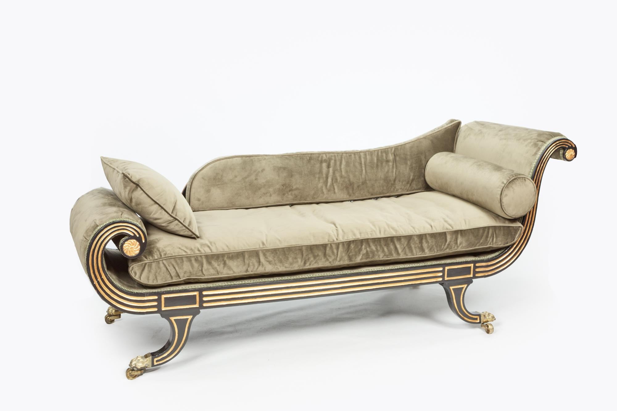 Fine Regency ebonized and gilt heightened chaise longue in the manner of Thomas Hope

Early 19th century Regency ebonised and gilt heightened chaise longue in the manner of Thomas Hope, the reeded show-wood frame with twin scroll ends with flower