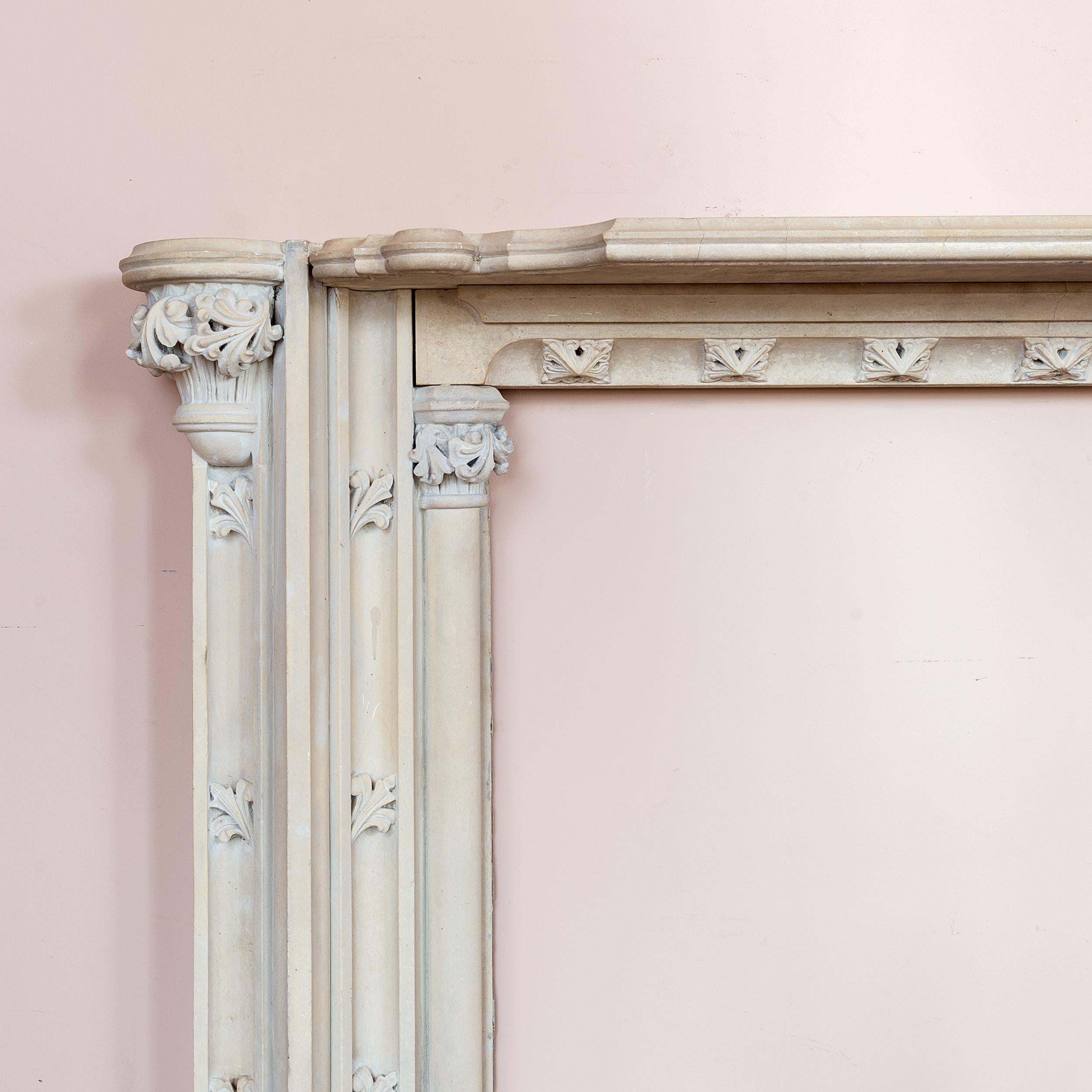 A fine Regency Gothic Revival Painswick stone fire surround, early nineteenth century, the elaborately shaped and moulded shelf above frieze with bed-mould and canted lower-lip with square fleur-de-lys paterae, the moulded jambs with foliate