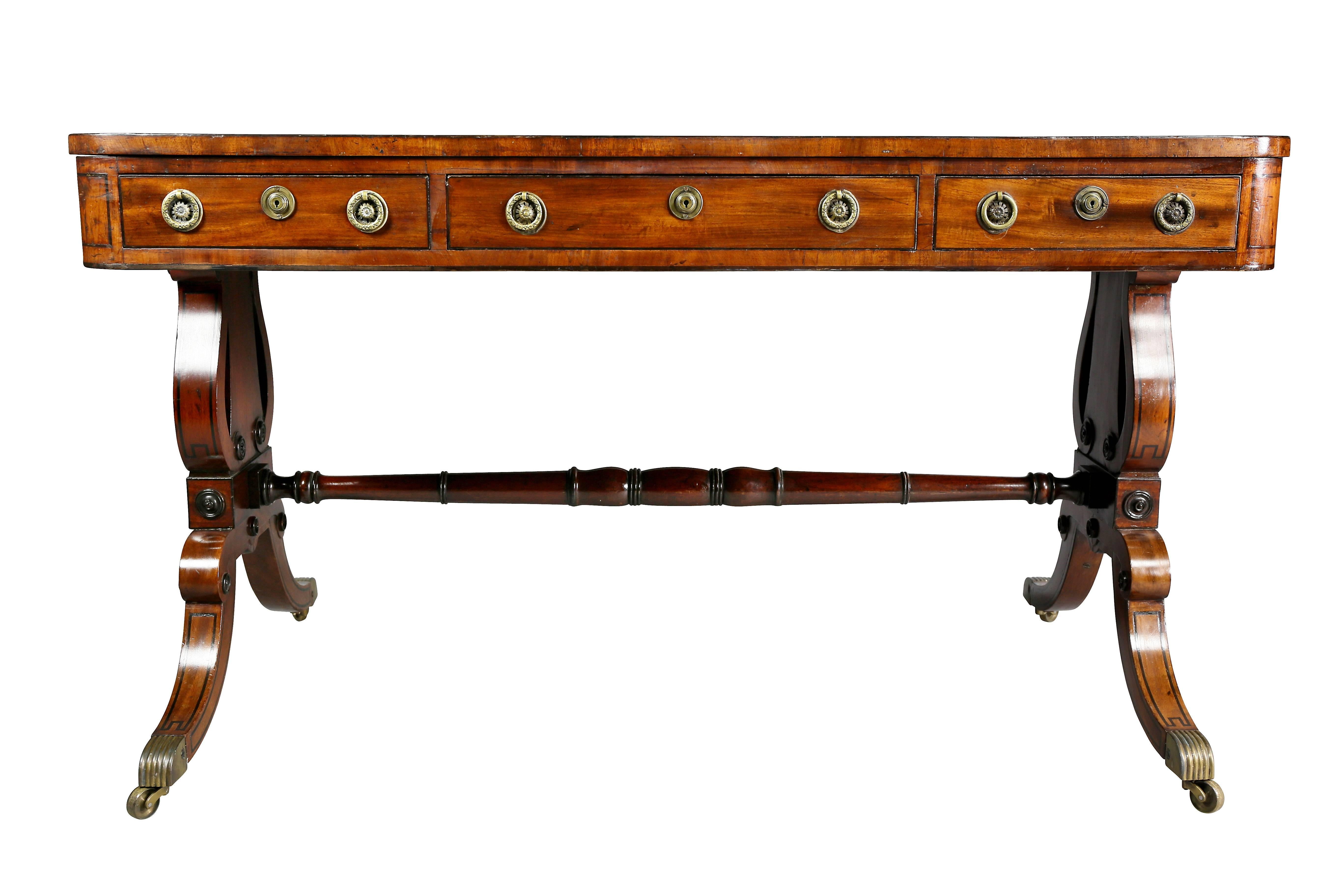 With new beautifully tooled green leather top with drawers on both sides, one side with three the other with a long drawer, raised on lyre form trestle base with mounted bosses and ebony inlays, joined by a turned stretcher and raised on saber legs