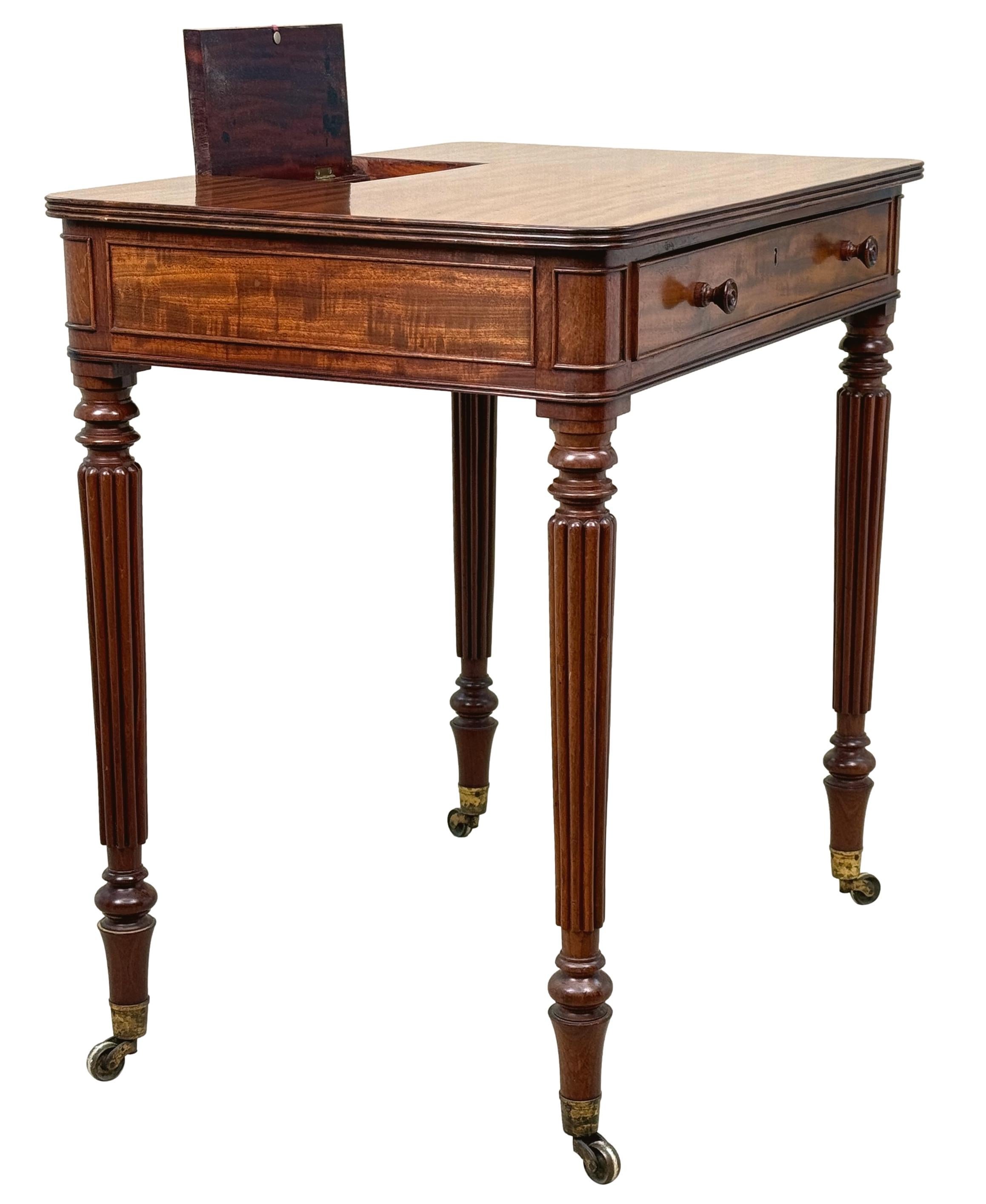 An Exceptional Quality Regency Period Mahogany Chamber Writing Table, In The Manner Of Gillows Lancaster, Having Superbly Figured Top With Hinged Flip Flap To Back, Enclosing Pen Tray And Inkwell Divisions, Over One Drawer With Original Turned Knobs