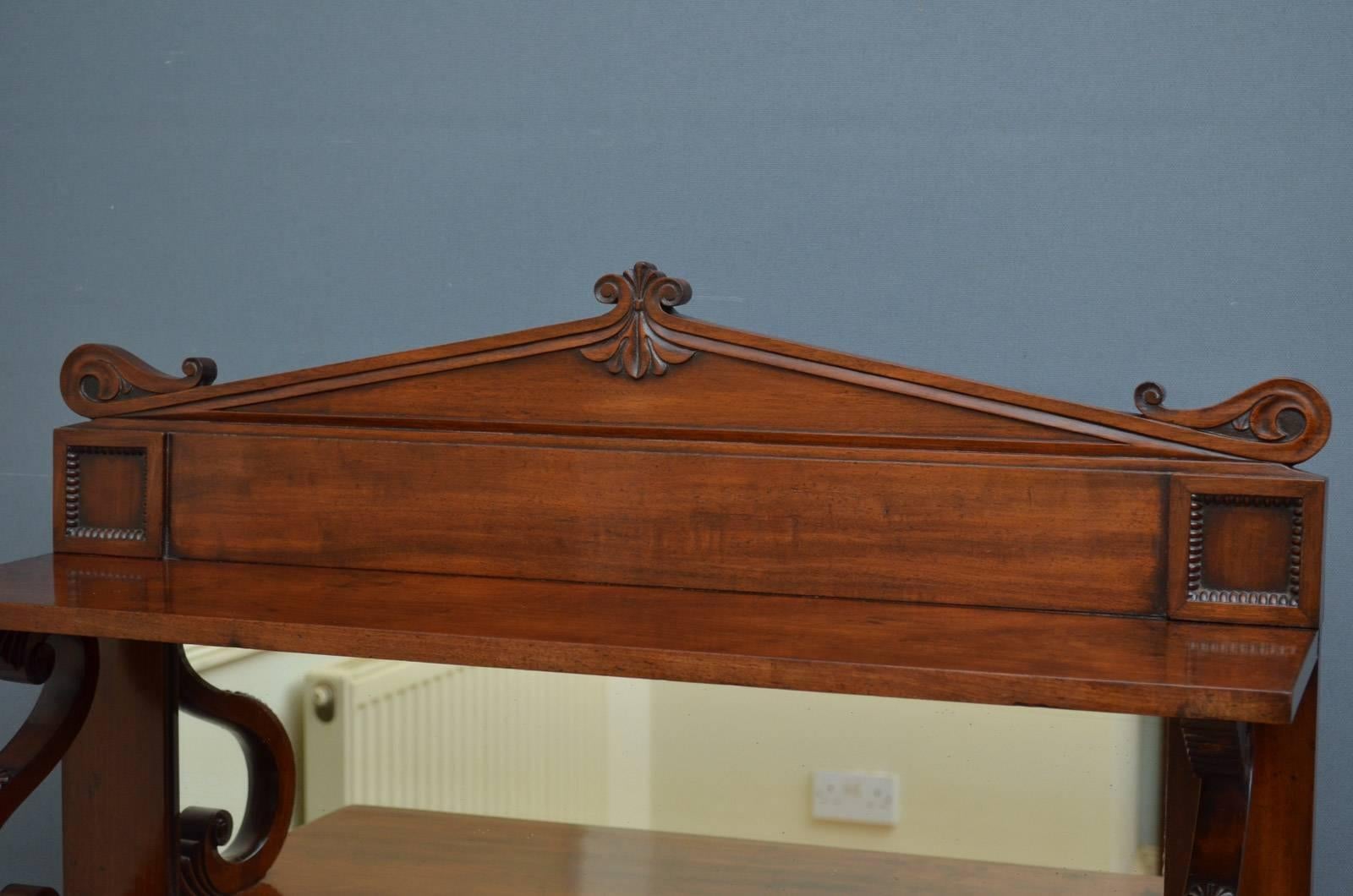 Sn4335 exceptional Regency mahogany chiffonier of narrow proportions, having architectural upstand on finely carved S scrolls and figured mahogany top above a pair of panelled doors fitted with original working lock and a key, original grill and a