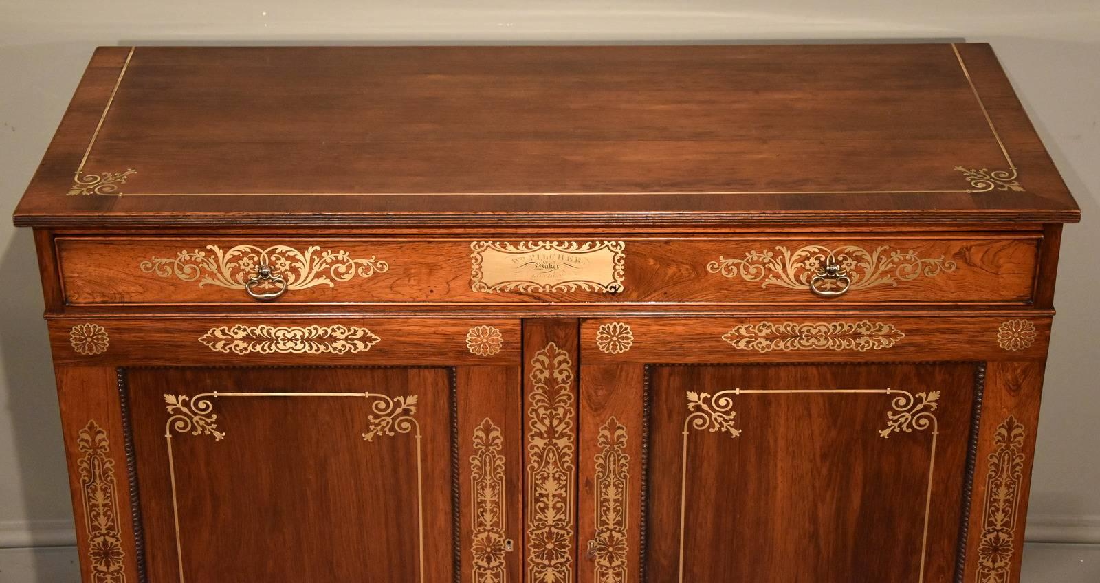 Fine Regency period rosewood brass inlaid side cabinet by Pitcher. This piece is illustrated in Markey L& N furniture by C Gilbert page 372 W M Picher London.

Dimensions:
Height 34