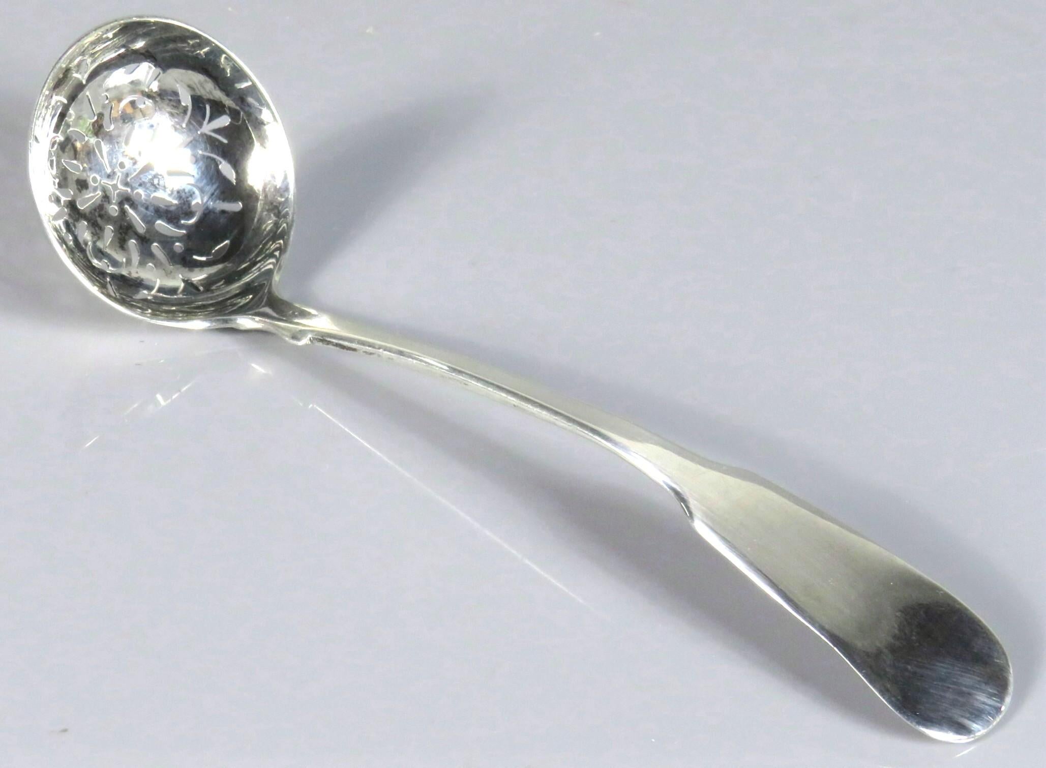 A fine early 19th century George IV sterling silver sugar sifting ladle, showing a finely pierced bowl and bearing Glasgow Hallmarks with date marks for 1826 and maker's marks for Scottish silversmith John Mitchell.