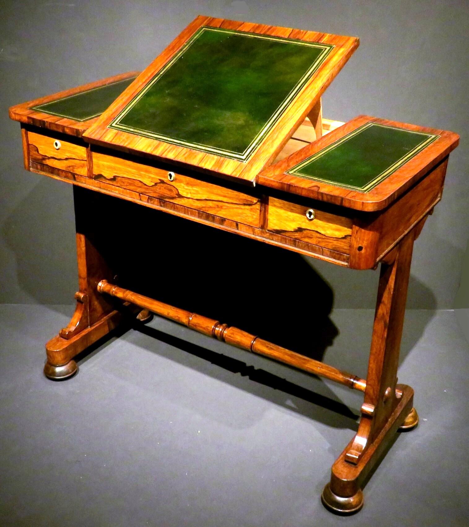 A fine early 19th century George IV period writing table / sofa table, showing a richly figured rosewood frame featuring a gilt-tooled black/green leather top with an elevating reading platform, overtop a frieze fitted with three small drawers all