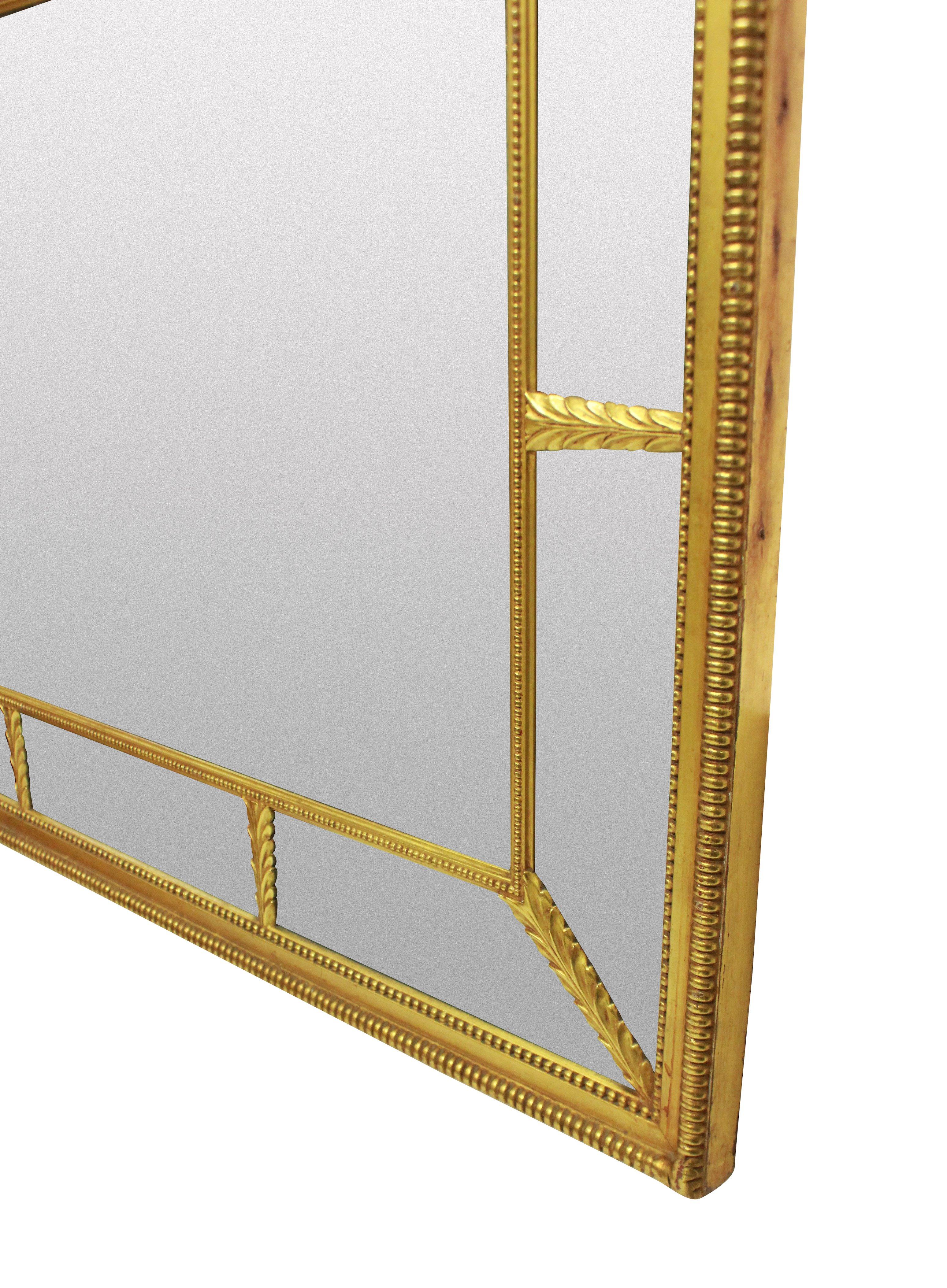 A fine English water gilded Regency style sectional mirror. The mirror could hang portrait or landscape and has its original glass, which has natural foxing and discoloration in places.